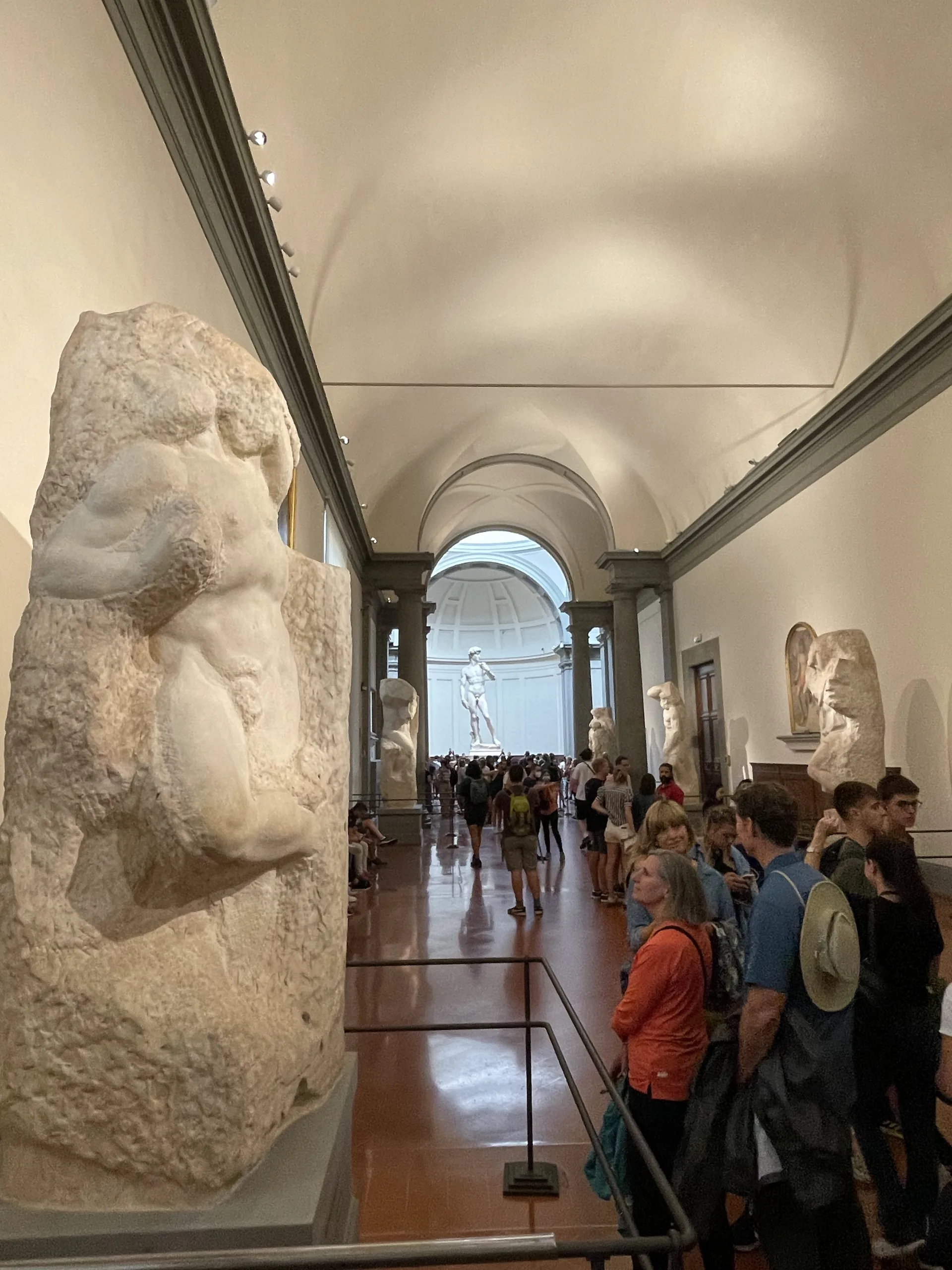 The Gallery of the Prisoners at the Accademia with David lit at the far end