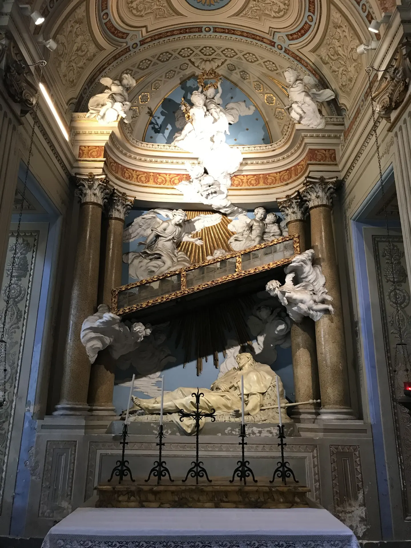 Baroque tomb monument with a reclining marble effigy in Santi Bonifacio e Alessio.