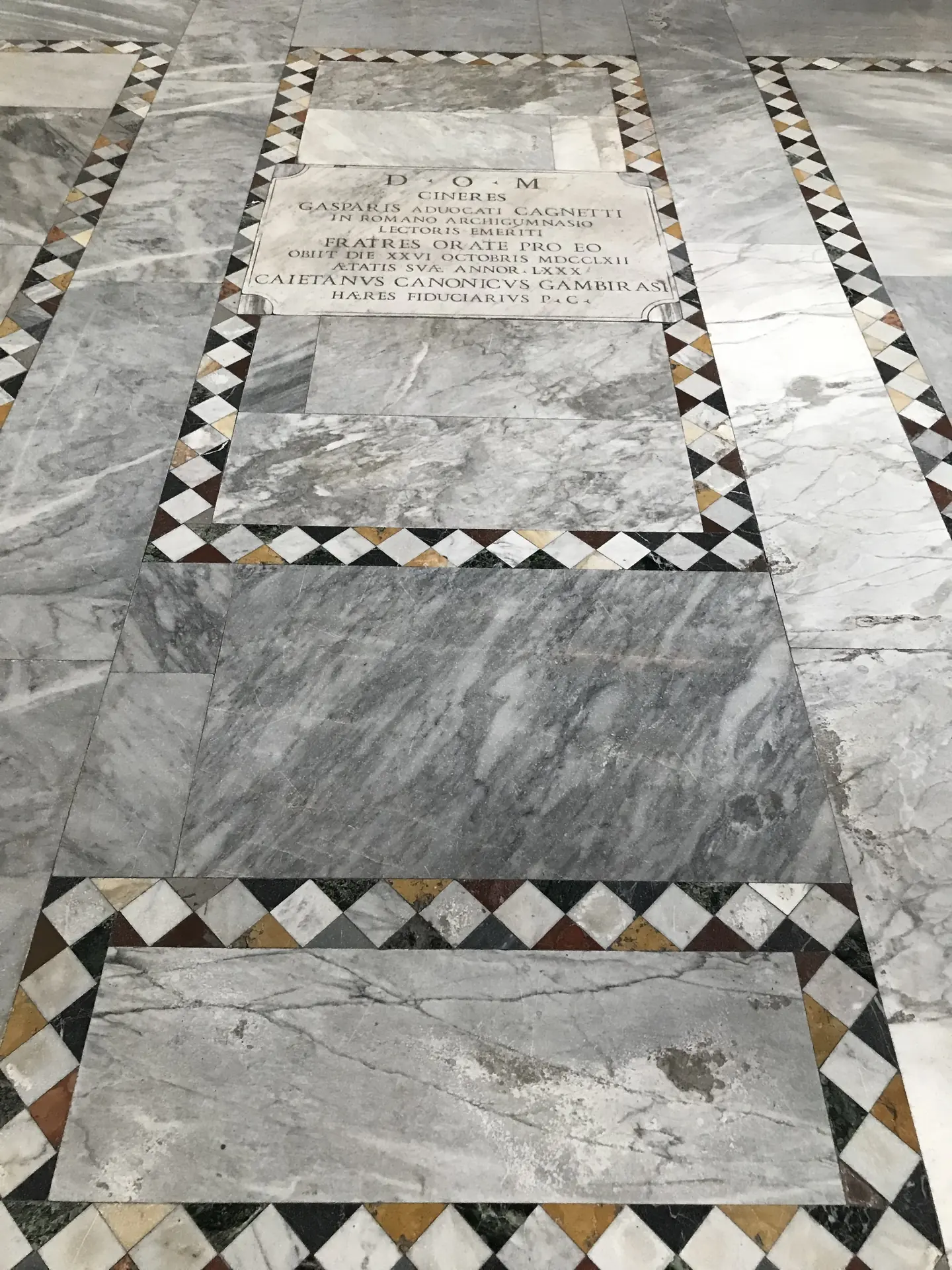 Cosmatesque mosaic tomb slab set into the marble floor of Santa Sabina.