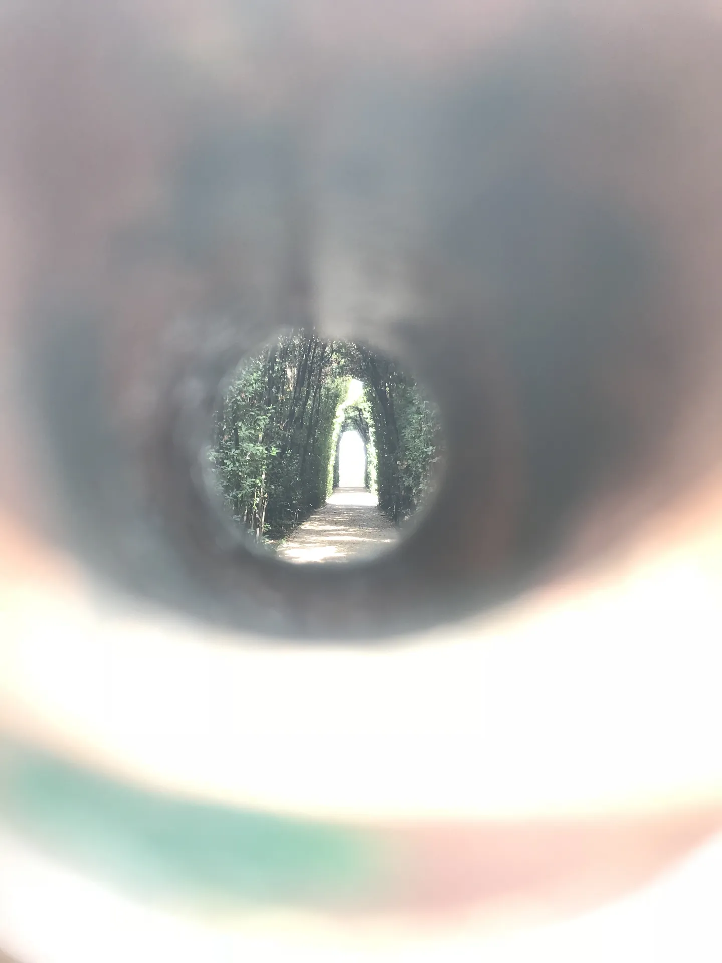 St Peter's dome framed by a hedged avenue seen through the Aventine keyhole.