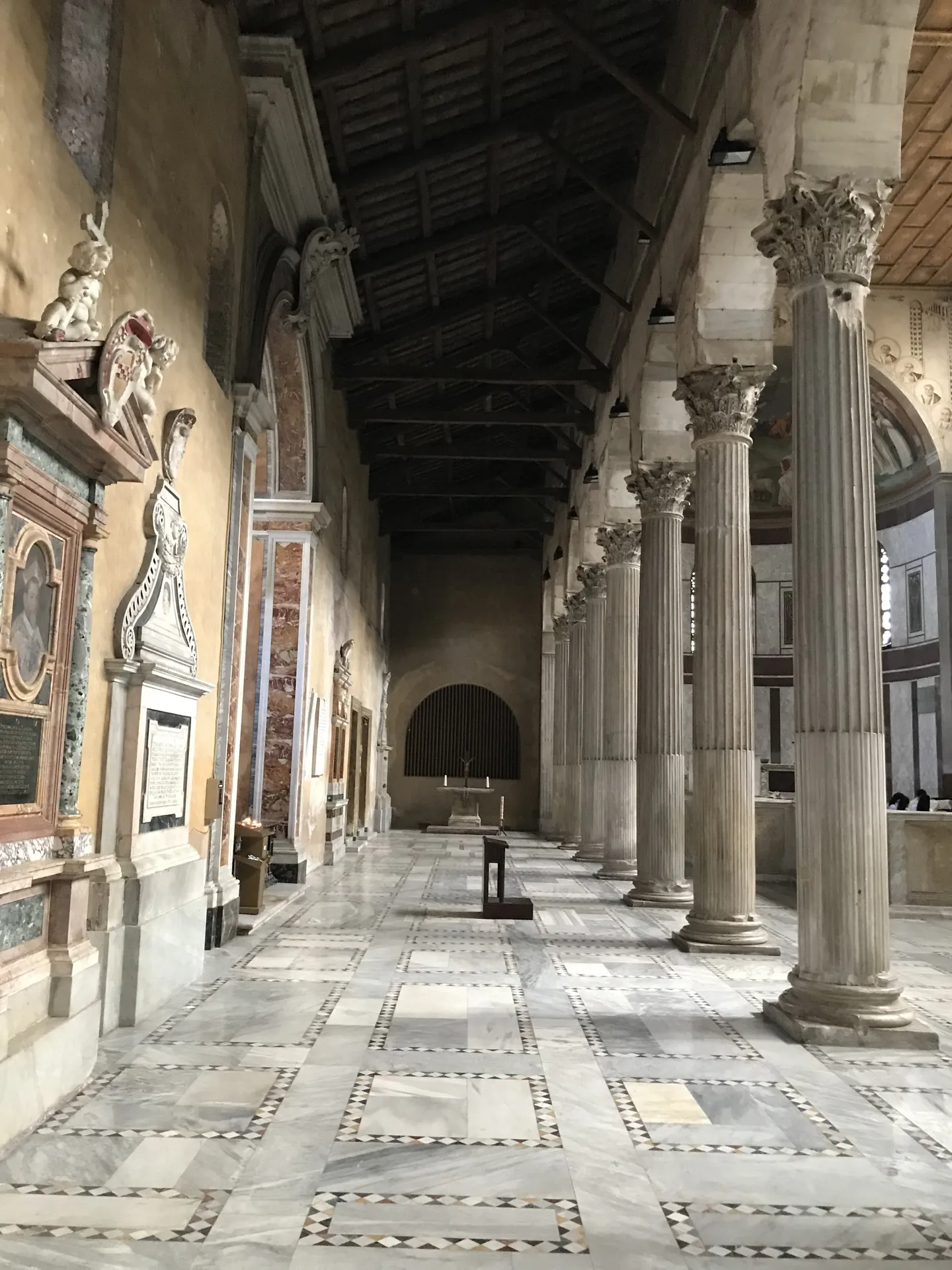 The early Christian colonnade and marble floor inside the Basilica of Santa Sabina.