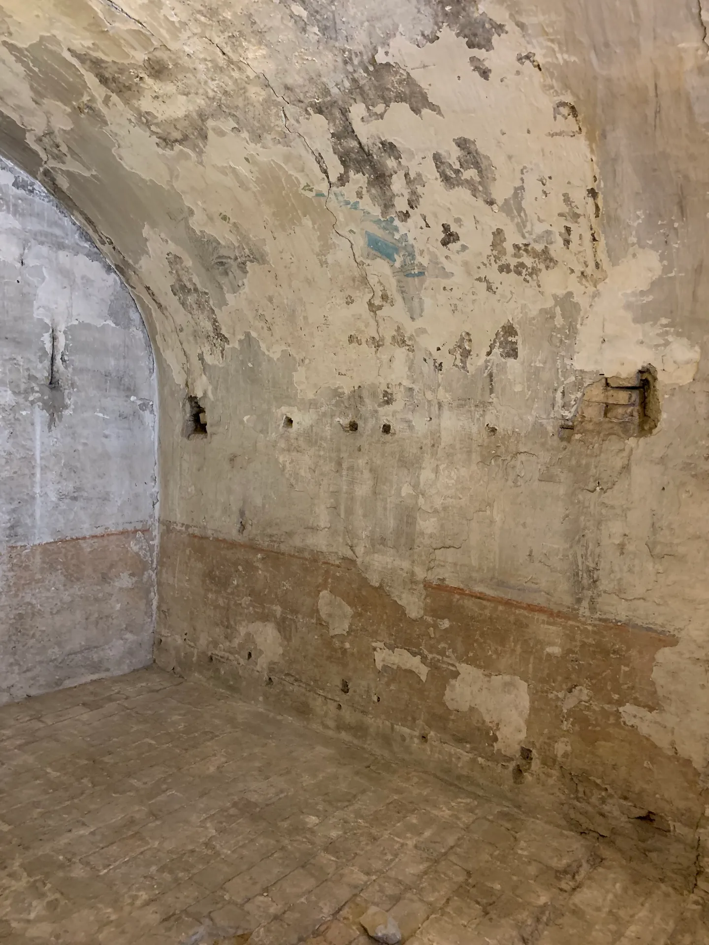 A bare stone cell with a vaulted ceiling in the New Prisons of Venice