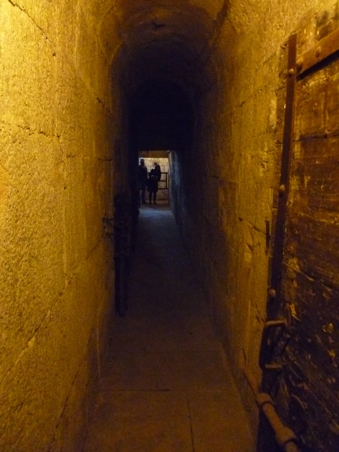 A lit stone corridor in the prisons of the Doge's Palace