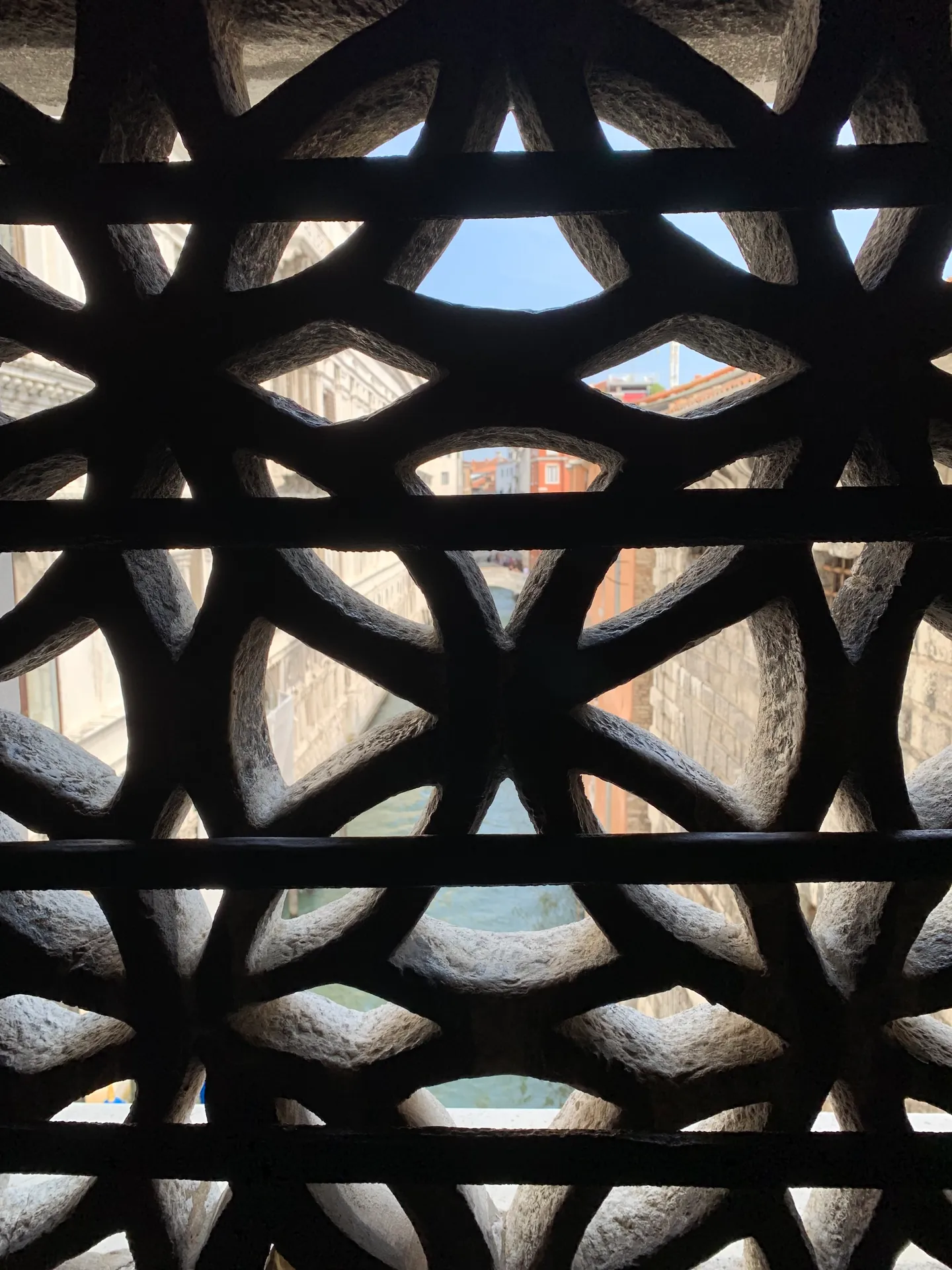 Light coming through the carved stone lattice of the Bridge of Sighs
