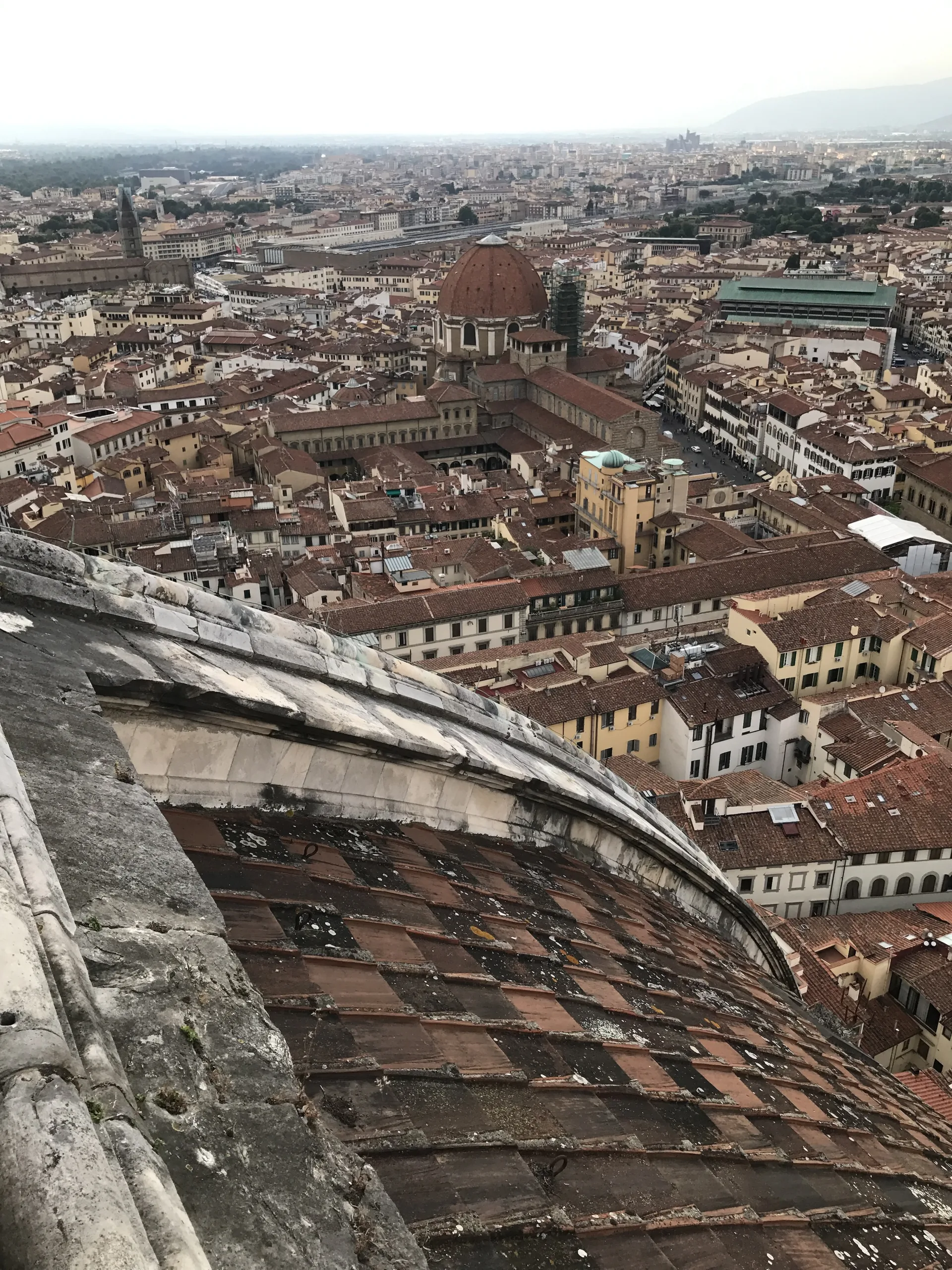 The dome's own red-tiled outer shell falling away over the rooftops of Florence