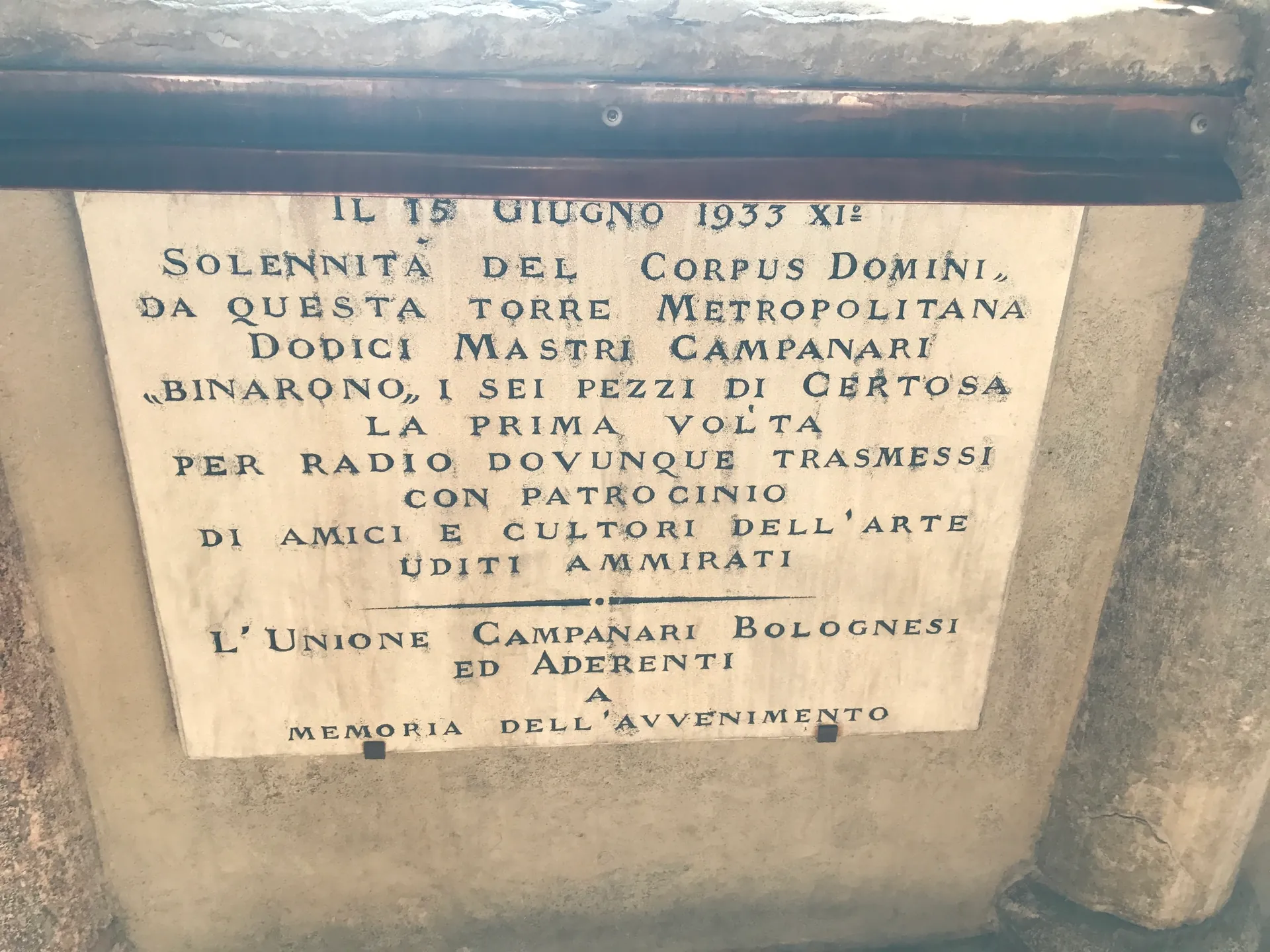 Carved marble inscription from 1933 commemorating a radio broadcast of the Bologna bells.