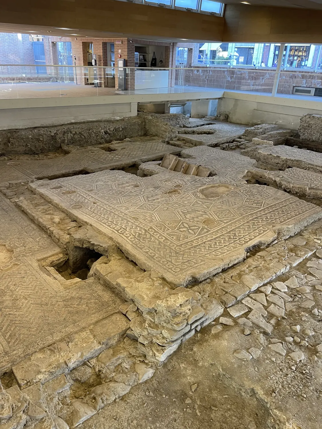 Roman mosaic floor and foundation walls at the Domus del Chirurgo excavation in Rimini