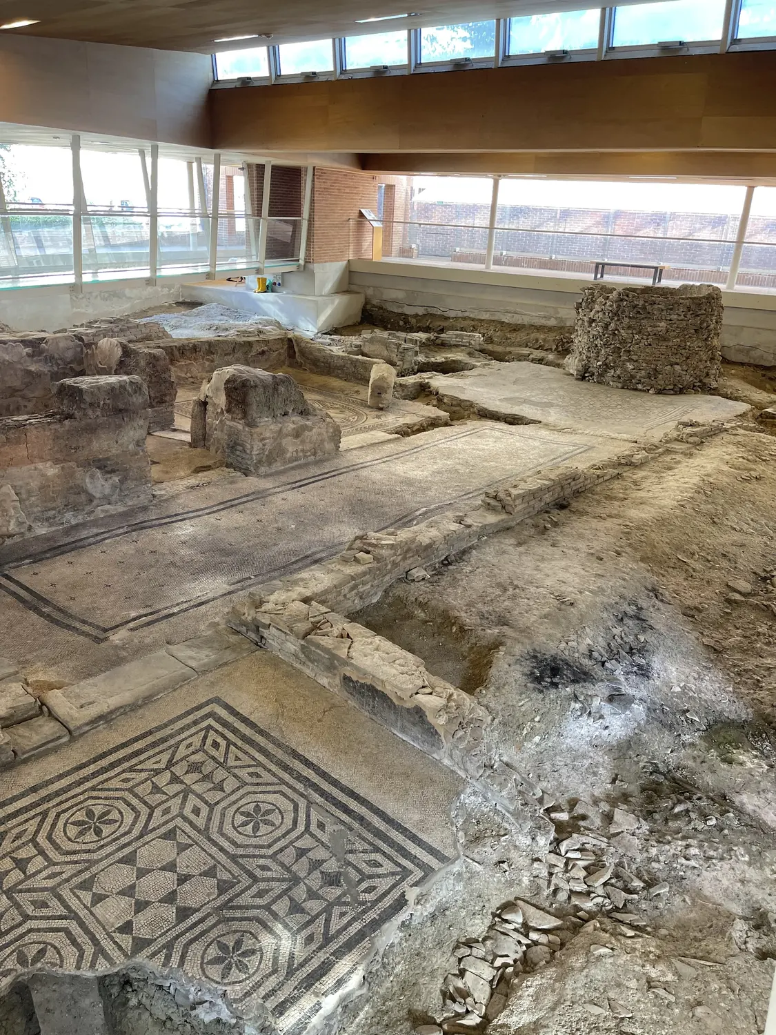 Excavated Roman house of the Domus del Chirurgo under a glass canopy in Rimini
