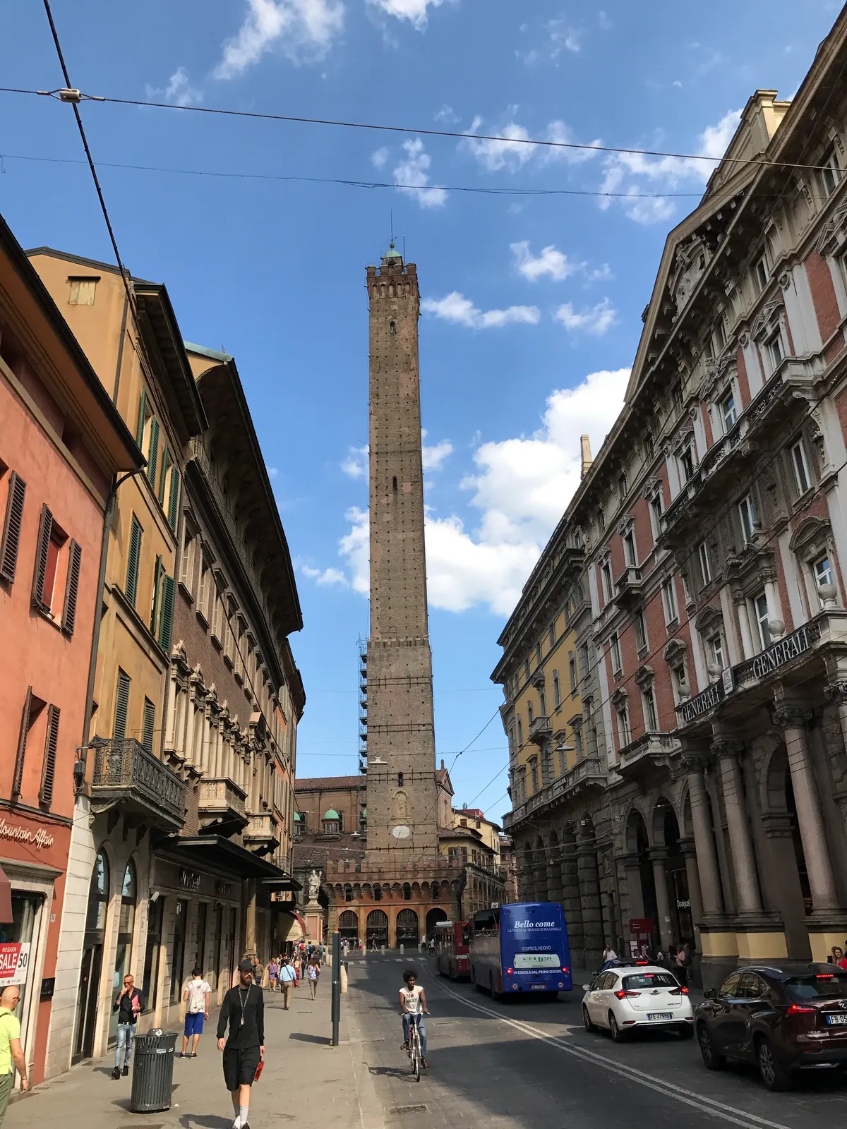 The Asinelli tower rising above buildings at the end of Via Rizzoli in Bologna.