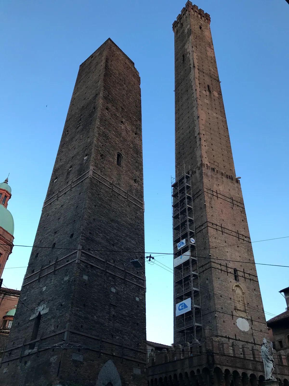 The Asinelli and leaning Garisenda towers standing together above Bologna.
