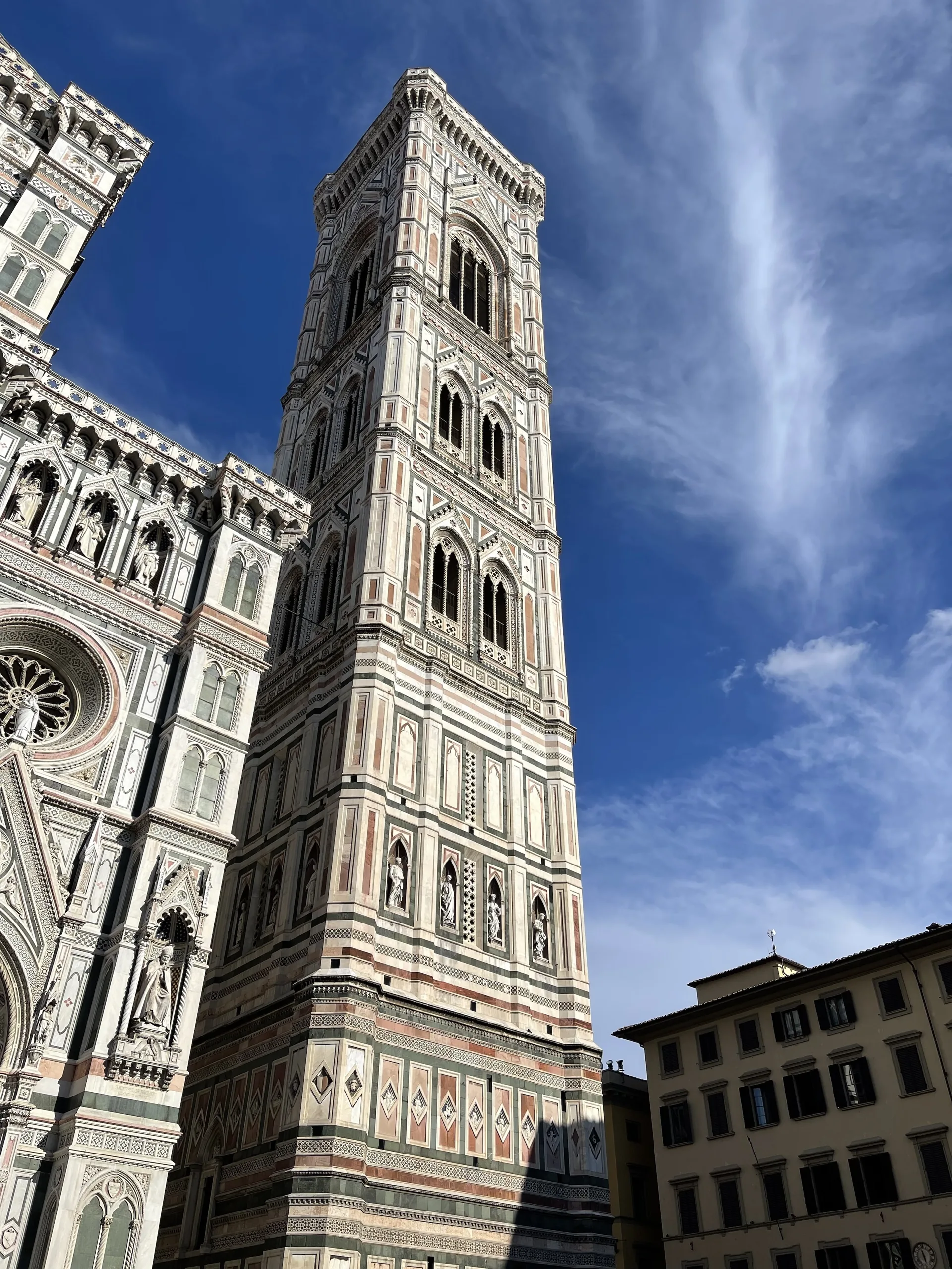 Giotto's campanile rising the full height of its five storeys against a blue sky