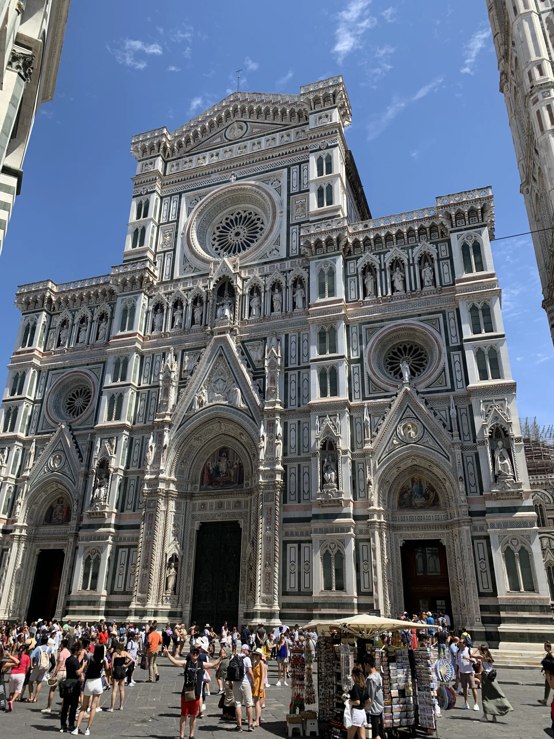 The full west front of Santa Maria del Fiore rising above the crowd in the square