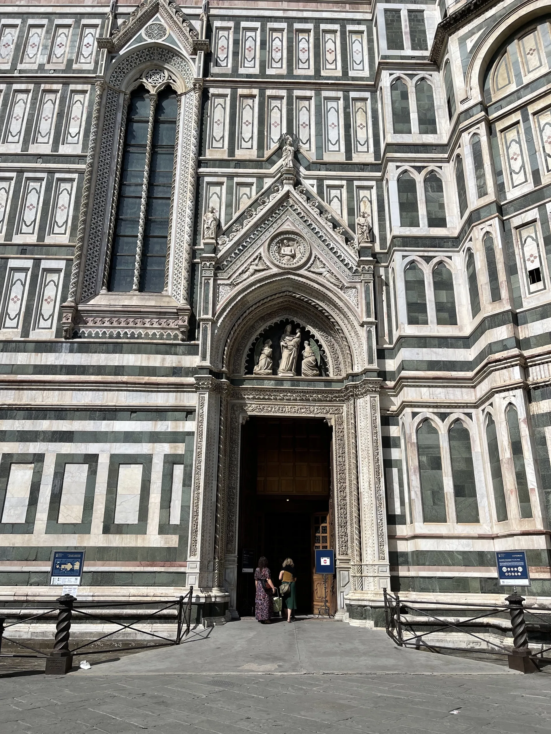 The central bronze doors and carved gable of the cathedral facade