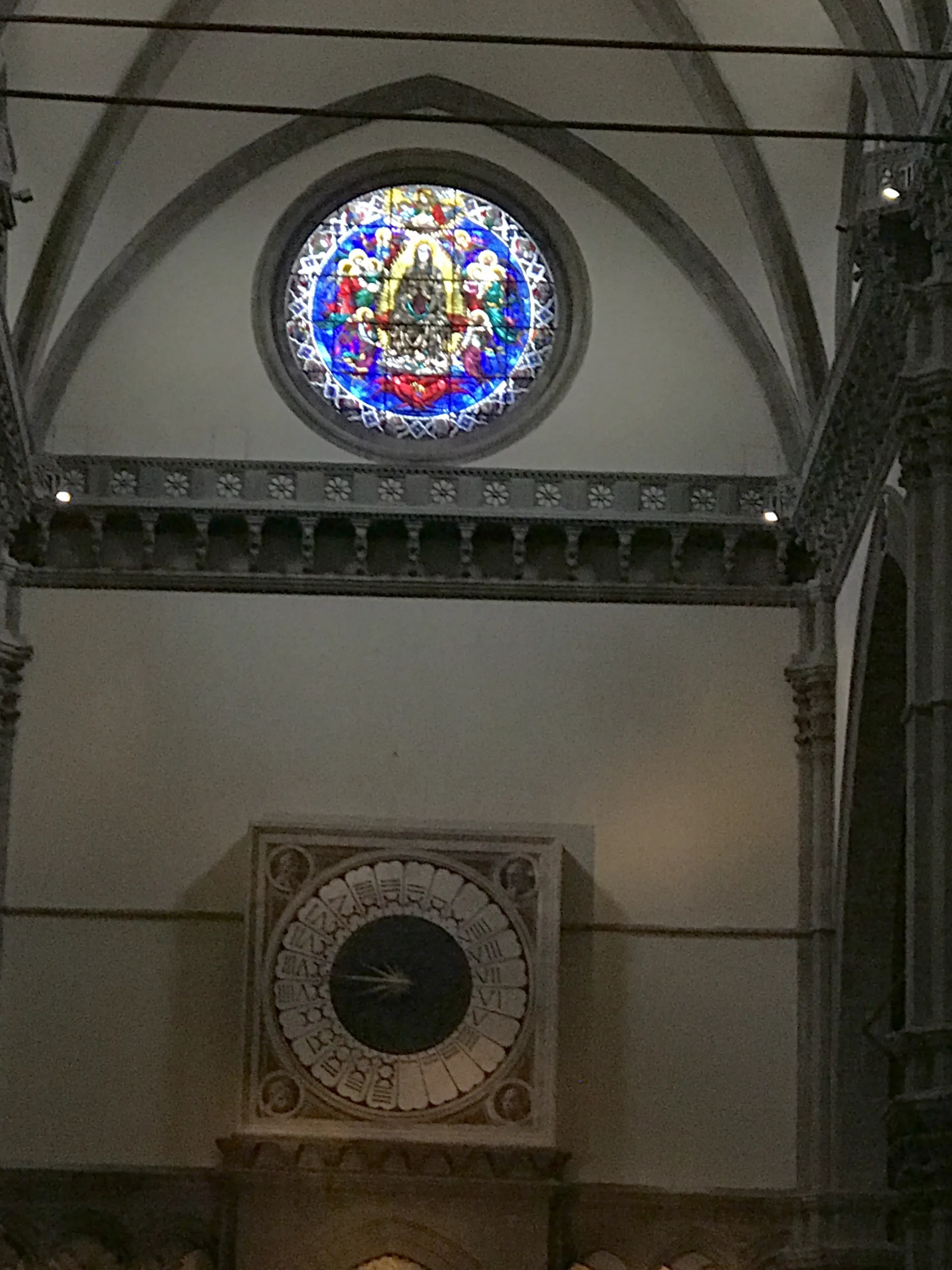 The one-handed liturgical clock painted by Paolo Uccello in 1443 on the inside of the cathedral's west front, below the stained-glass rose window