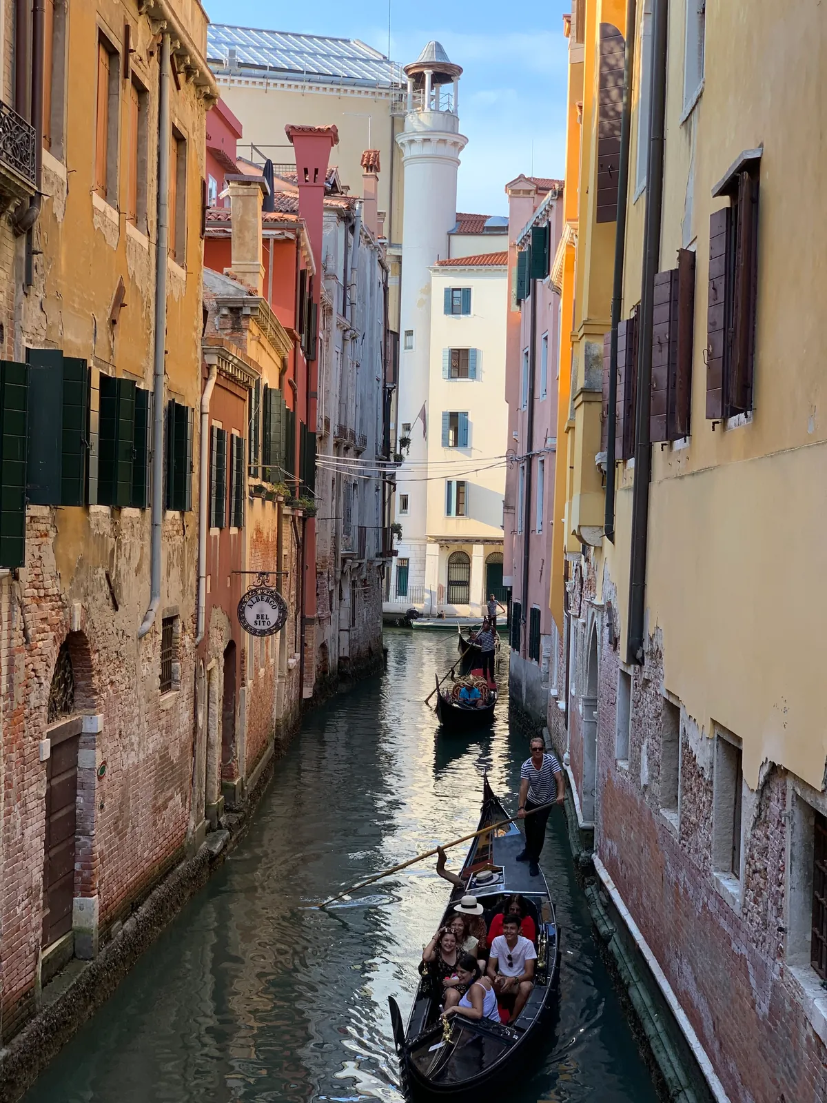 Gondolas passing one another in a narrow Venetian canal