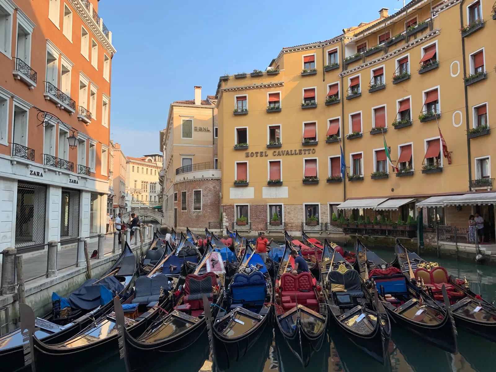 Moored gondolas below Venetian palazzi at a gondola basin