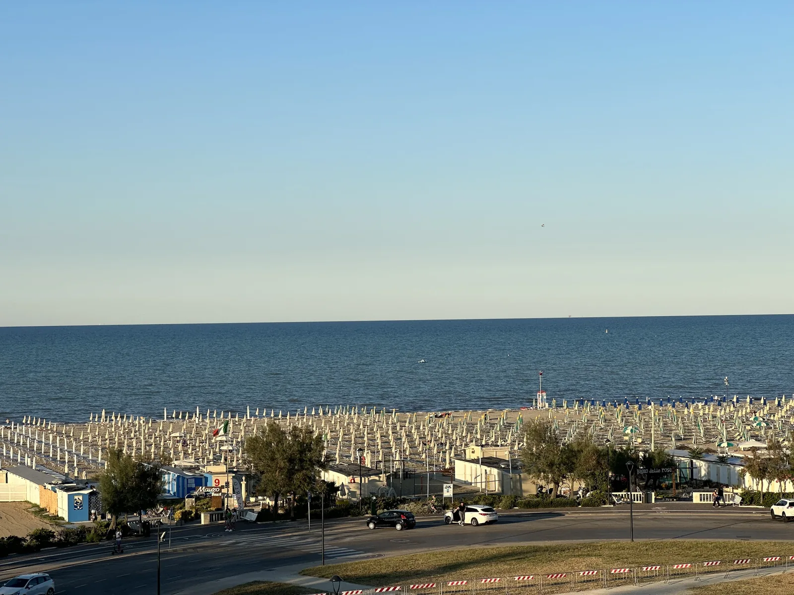 Lettered rows of umbrellas and loungers on the Grand Hotel Rimini private beach