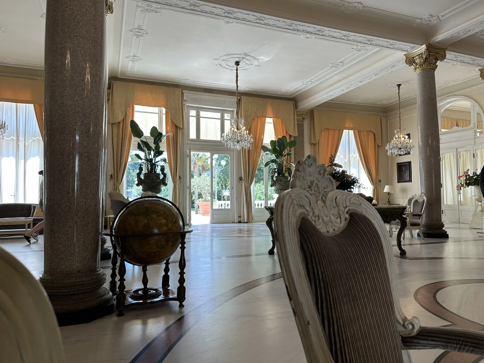 Liberty-era lobby with columns, mirrors and chandeliers at the Grand Hotel Rimini