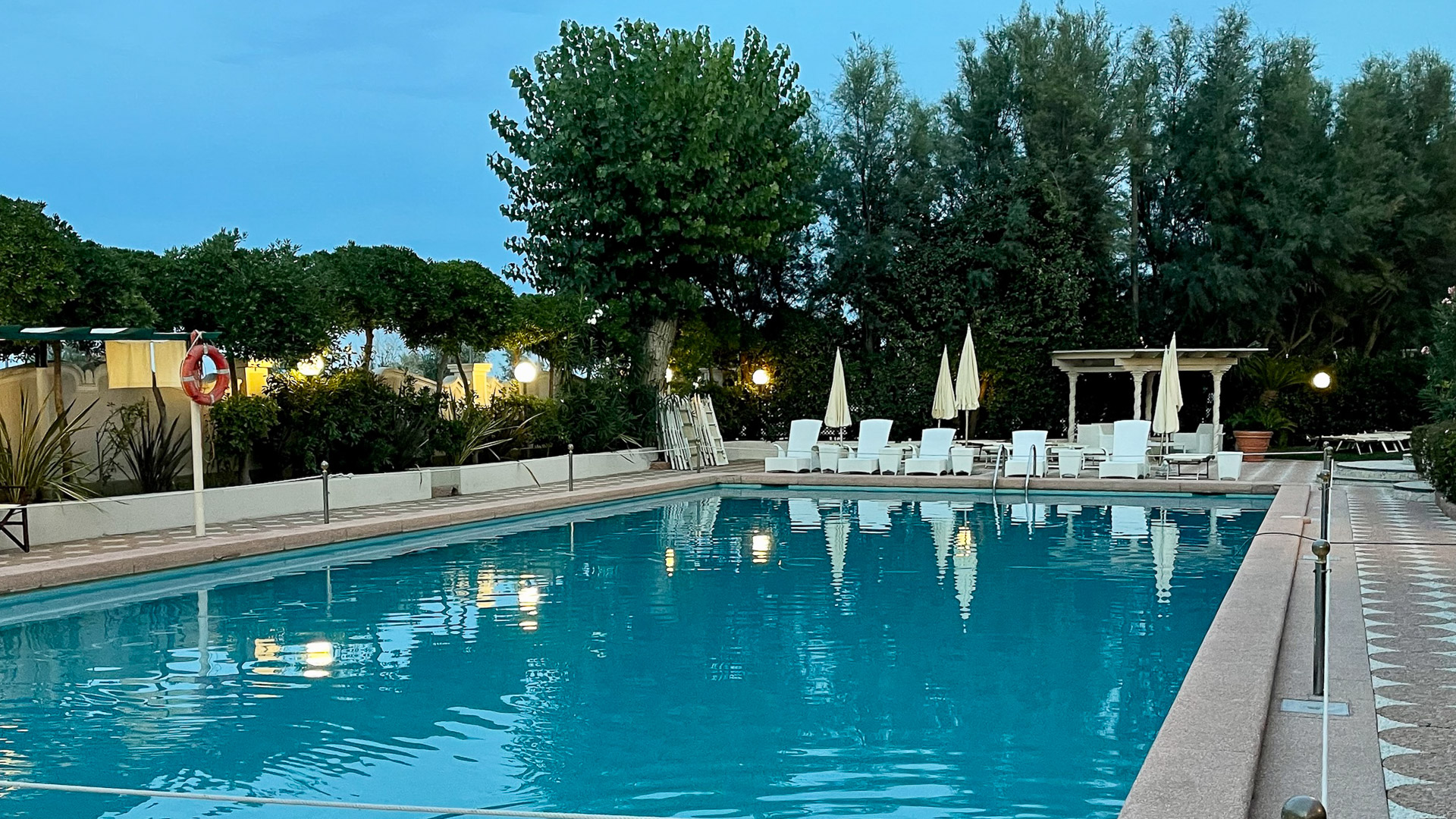 The Grand Hotel Rimini outdoor pool lit at dusk