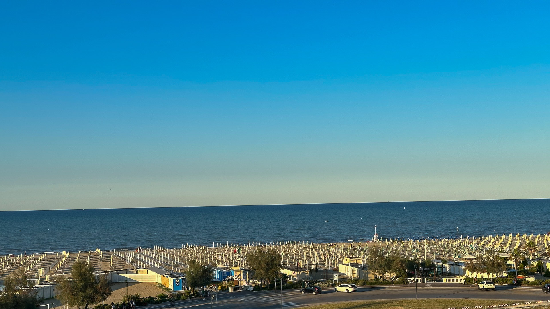 Rows of beach umbrellas in the morning seen from above at the Grand Hotel Rimini