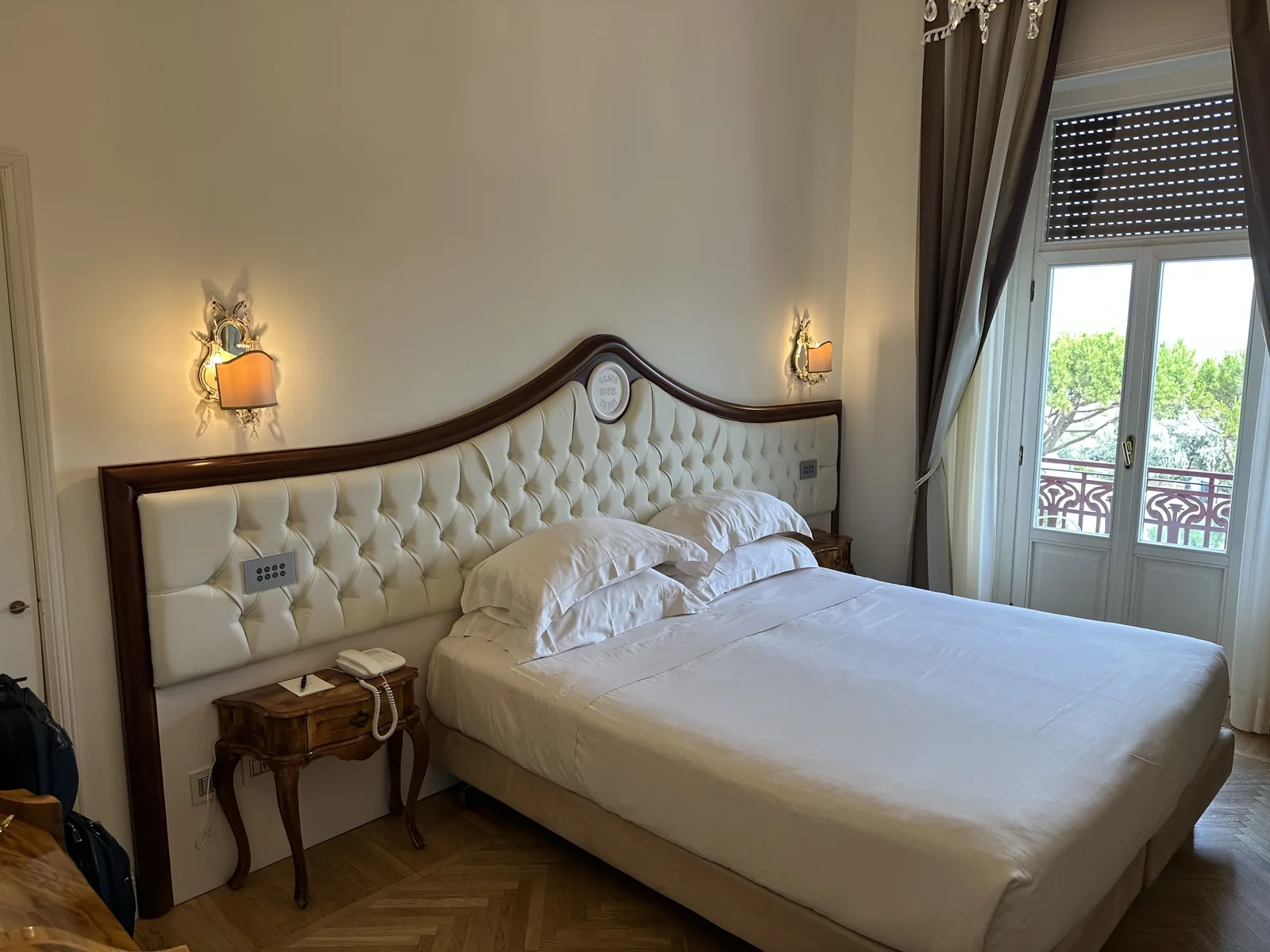 Made double bed in an old-world guest room at the Grand Hotel Rimini