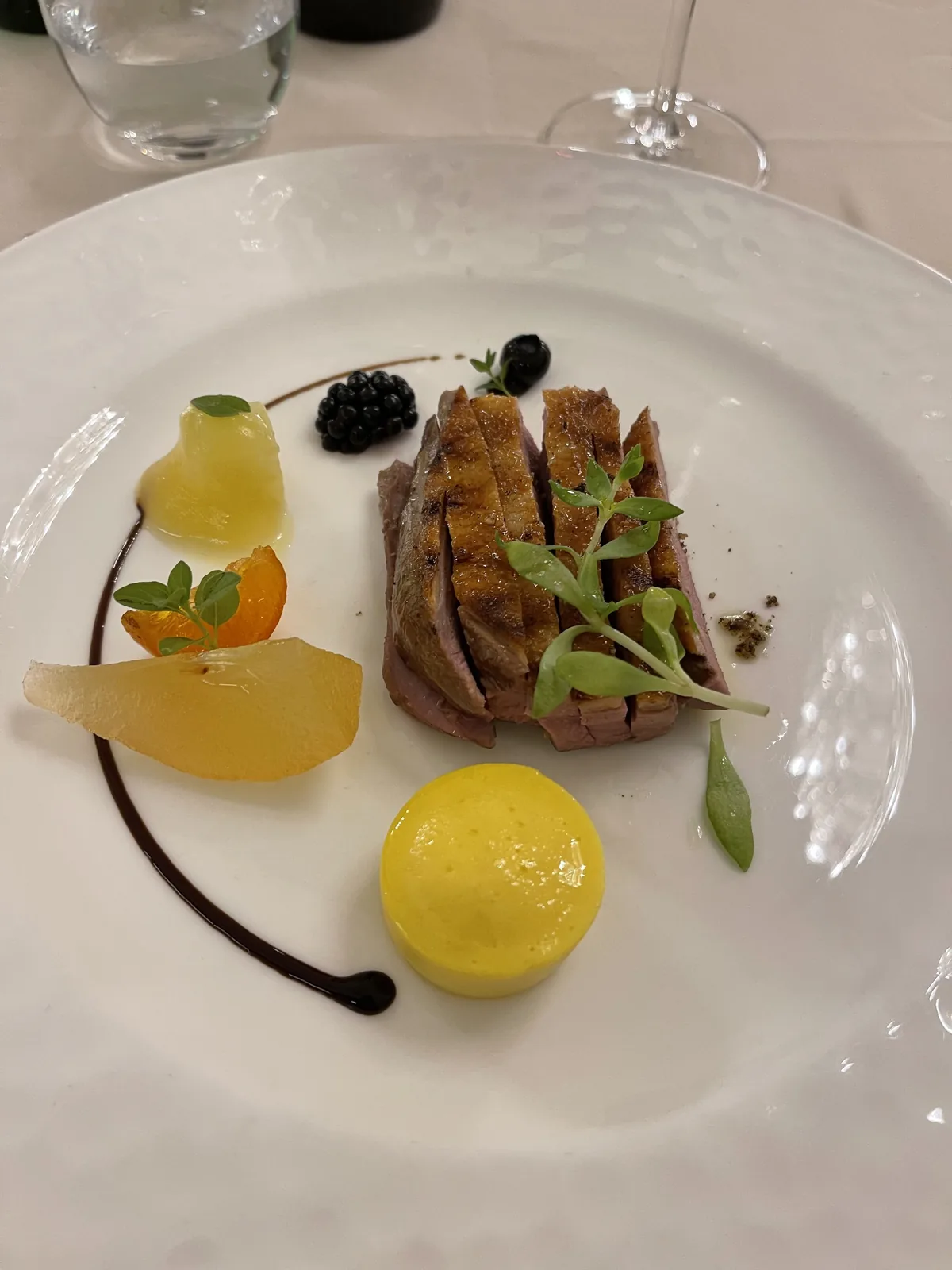 Plated duck course with orange in the Grand Hotel Rimini dining room