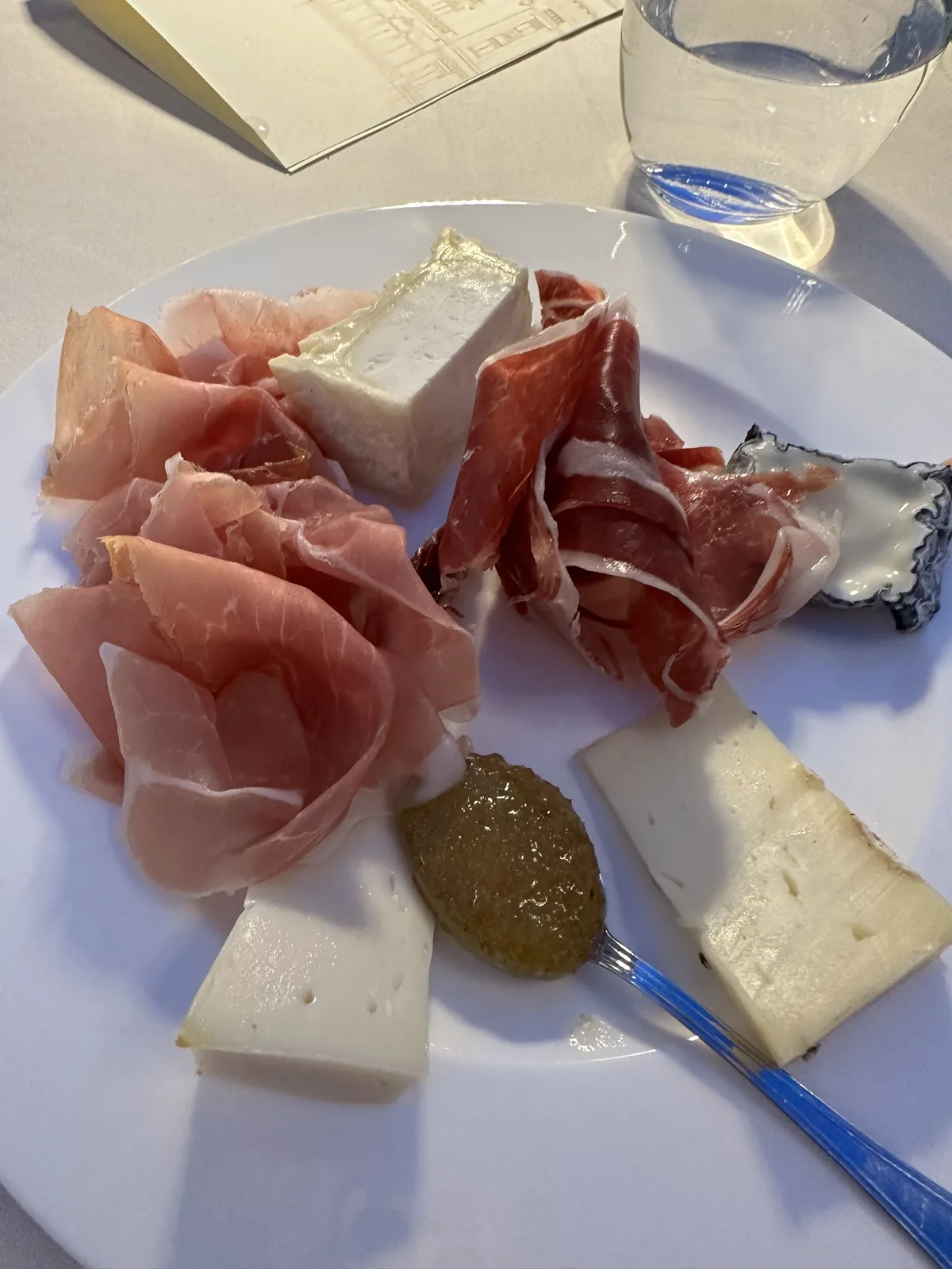 Plate of prosciutto and cheese with fig from the Grand Hotel Rimini buffet