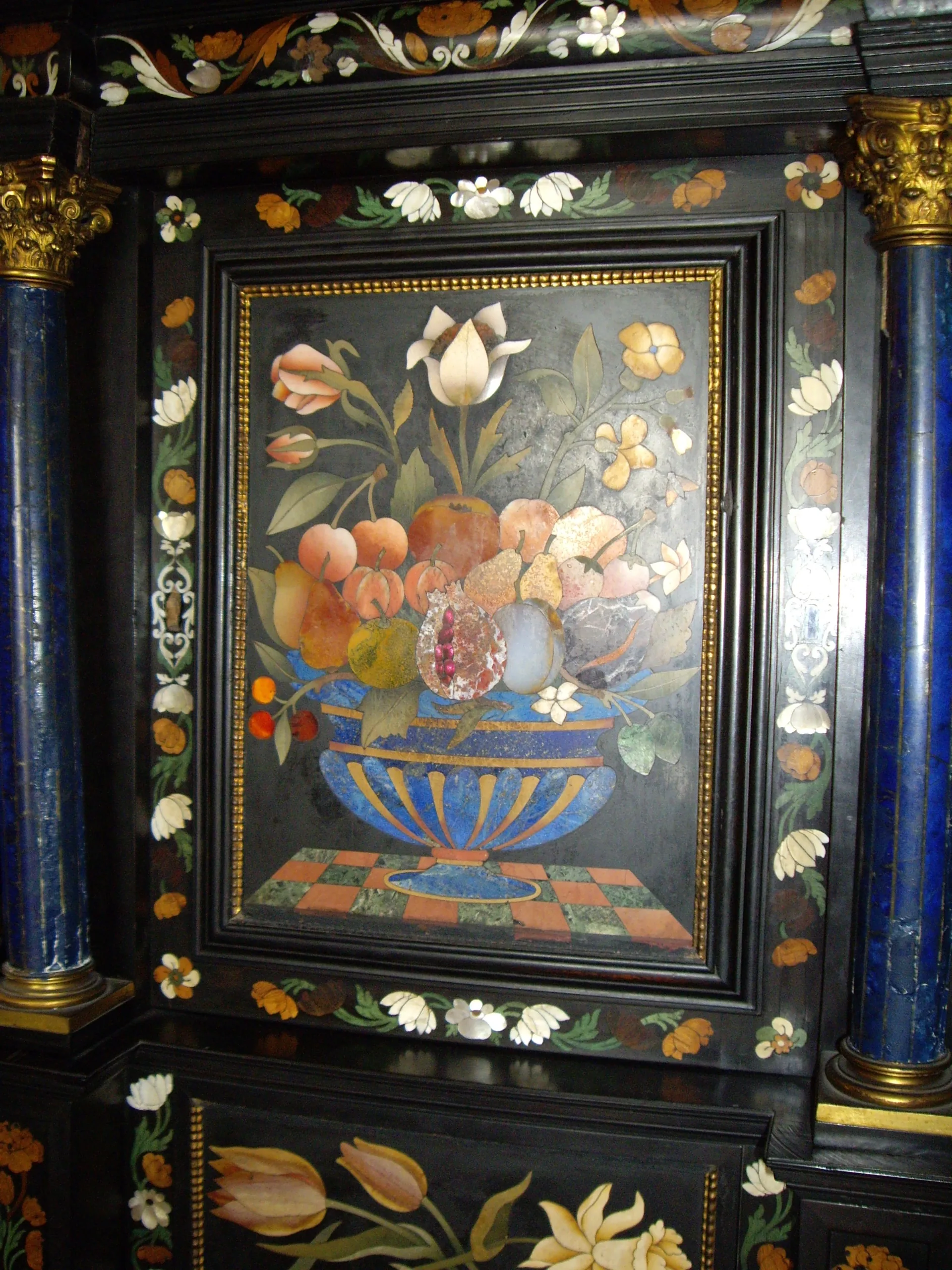A pietra dura panel of flowers and fruit inlaid in colored stone on a Palazzo Vecchio cabinet