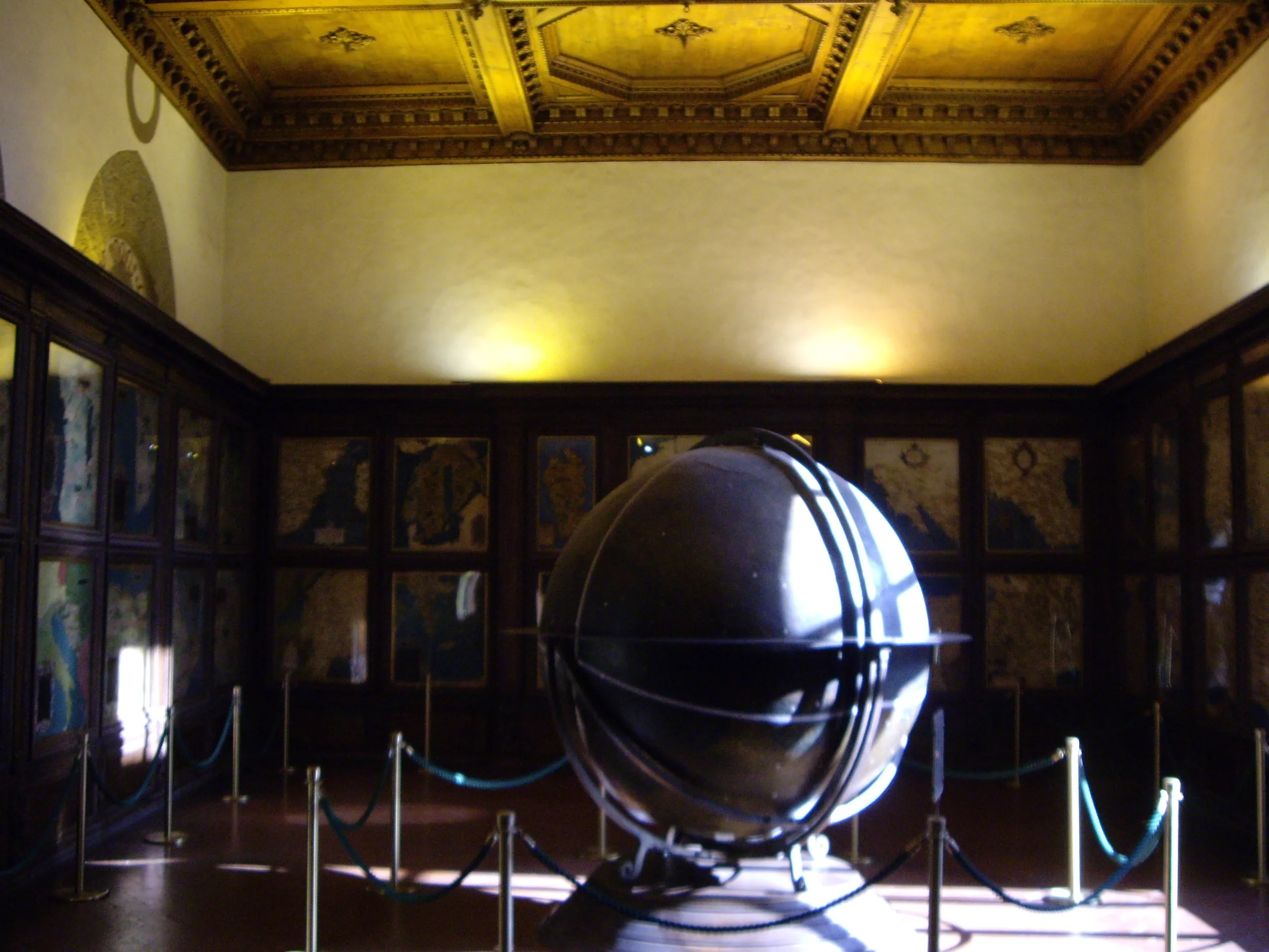 The Hall of Geographical Maps, its walls lined with sixteenth-century painted maps around a standing globe