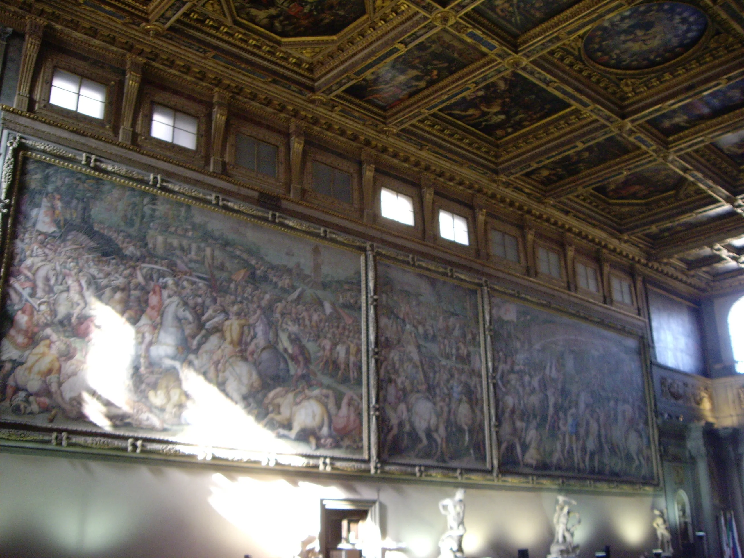 The battle frescoes and gilded ceiling running the length of the Salone dei Cinquecento