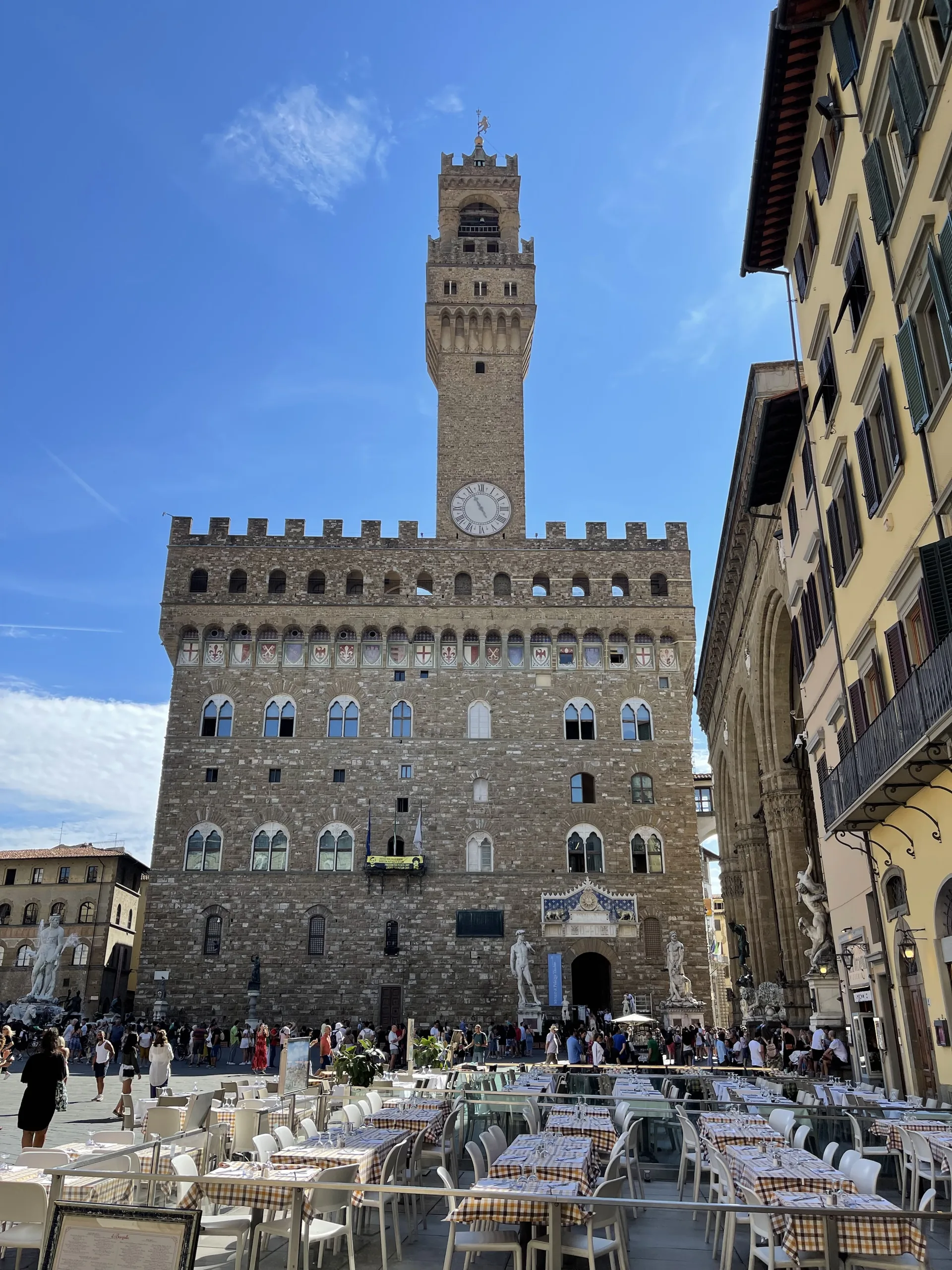 The Torre di Arnolfo set off-center on the Palazzo Vecchio front