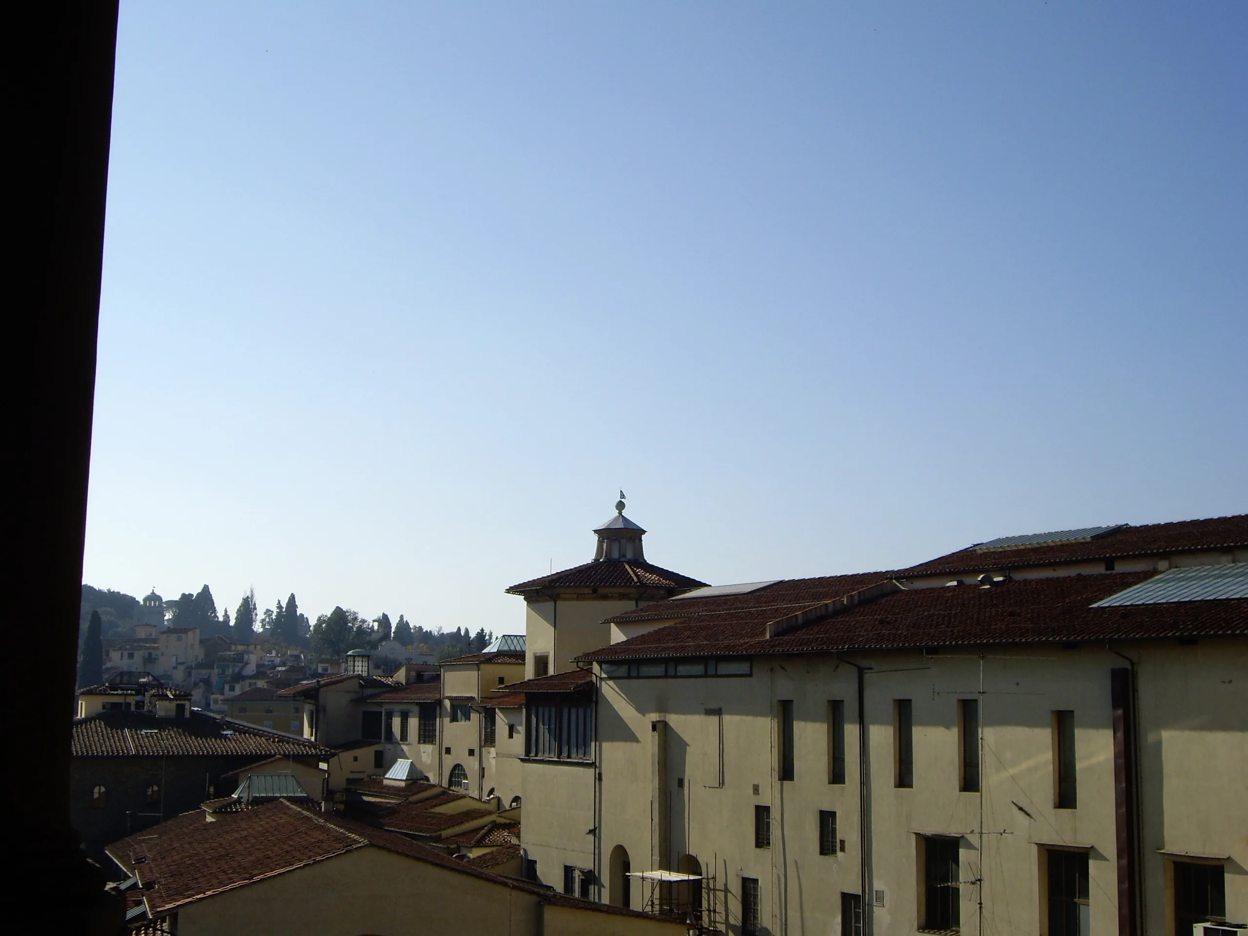 Terracotta rooftops and the Tuscan hills from the top of the Palazzo Vecchio
