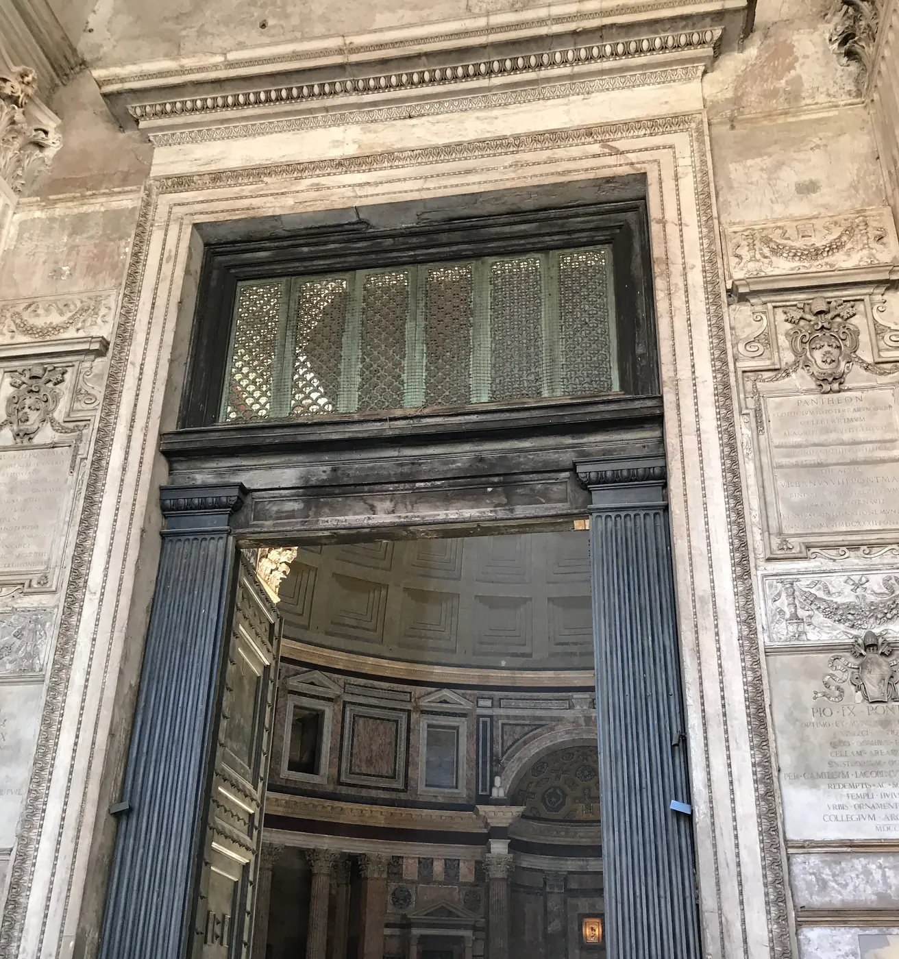 The great bronze doors of the Pantheon seen from the portico with the rotunda beyond