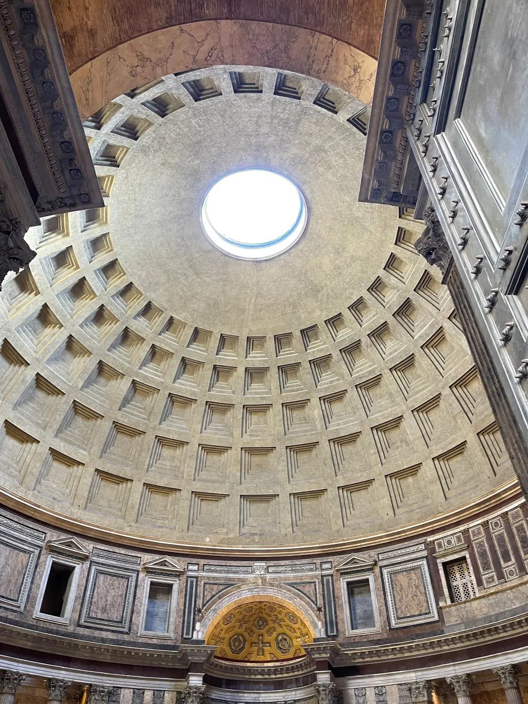 Pantheon dome and oculus with the gilded apse half dome and attic level below