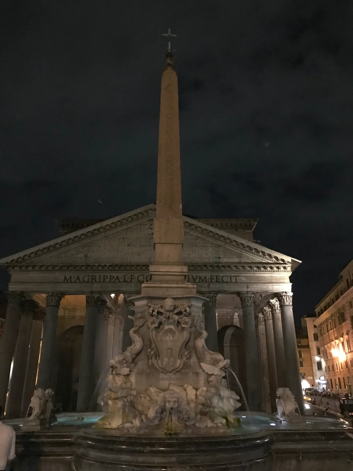 Pantheon fountain and obelisk at night with the floodlit portico behind