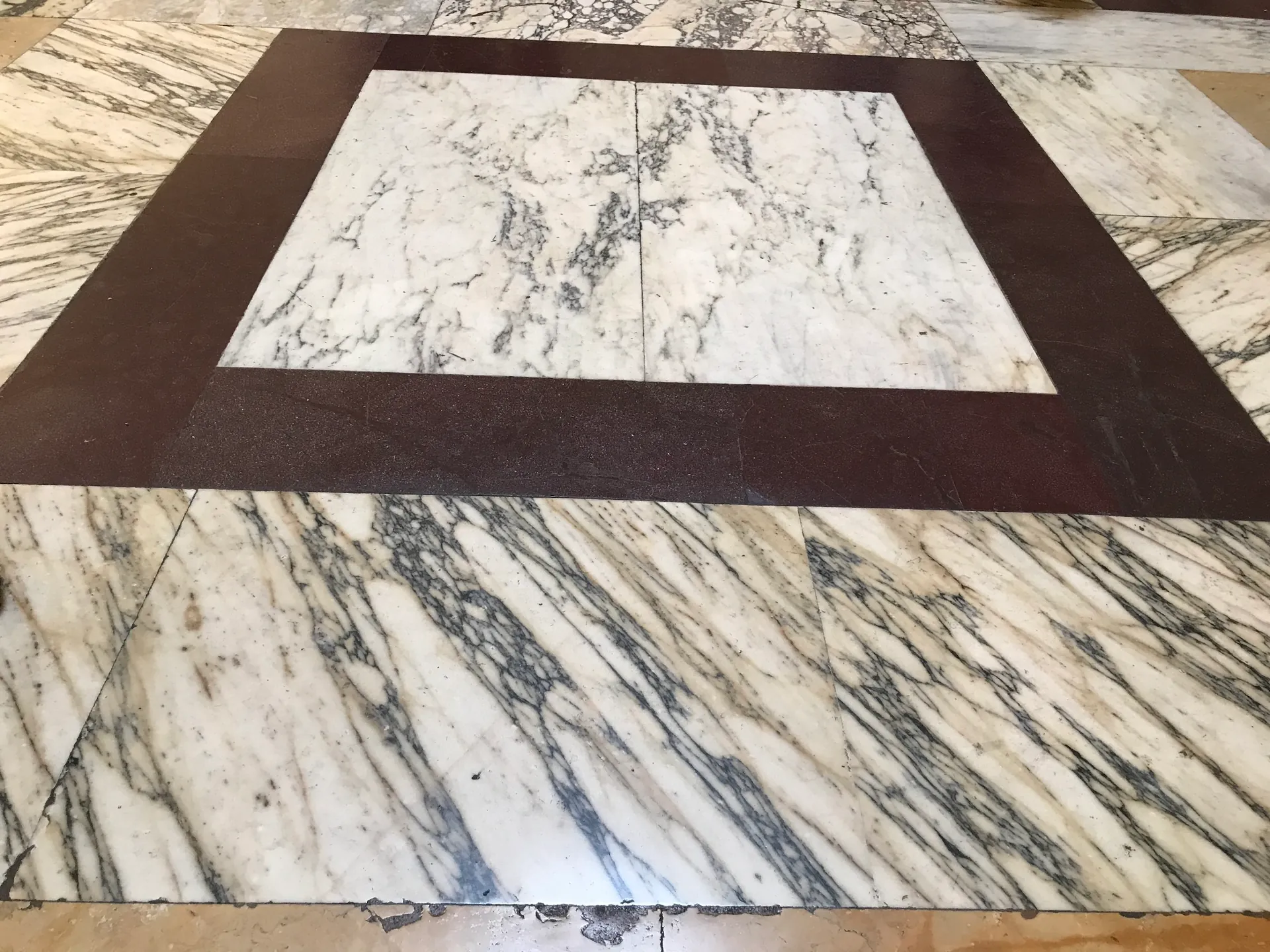Ancient geometric marble floor of the Pantheon in porphyry and pavonazzetto