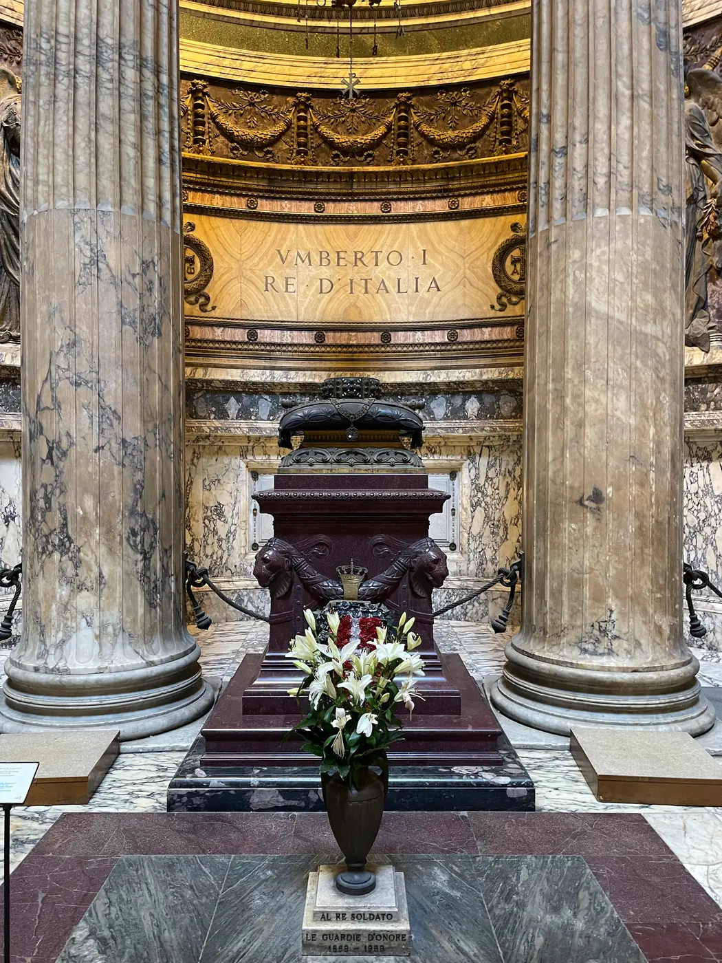 Porphyry tomb of King Umberto I and Queen Margherita in the Pantheon with fresh flowers