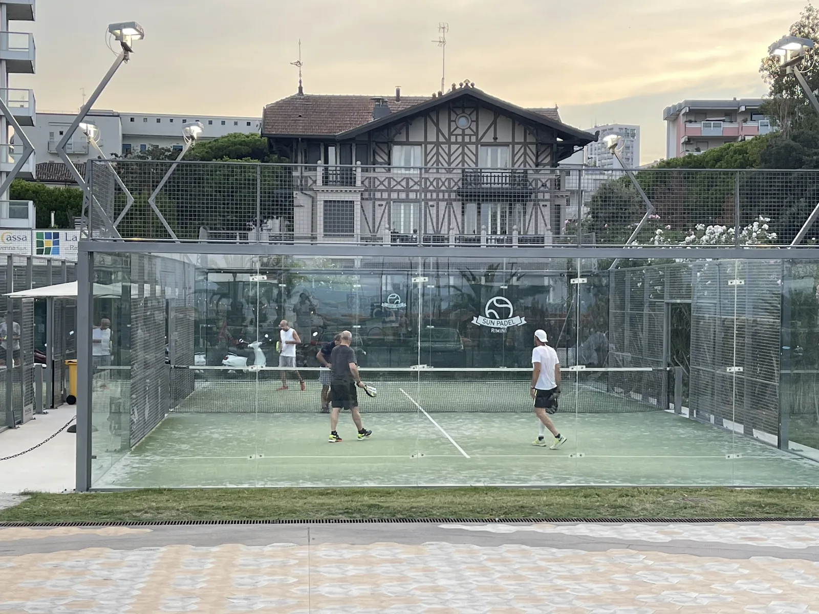 Glass-walled padel courts on the Rimini seafront at the Parco del Mare