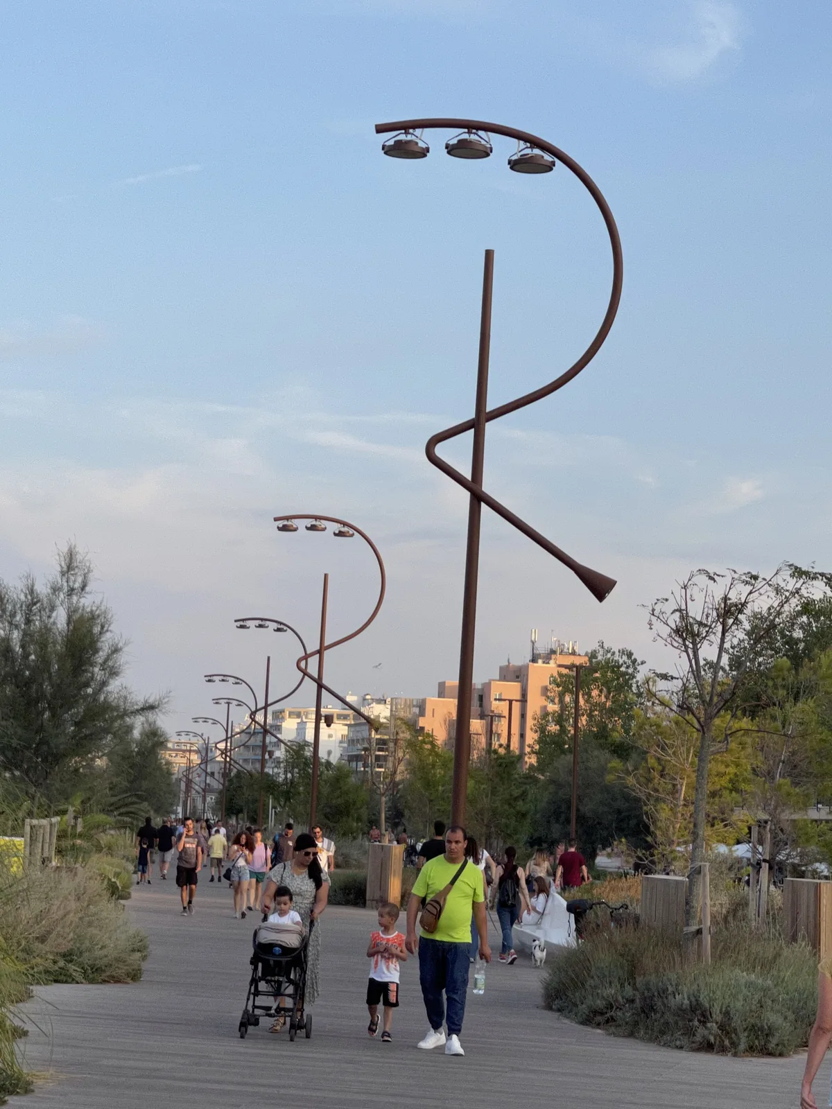 Two curved sculptural lampposts against blue sky on the Parco del Mare Rimini
