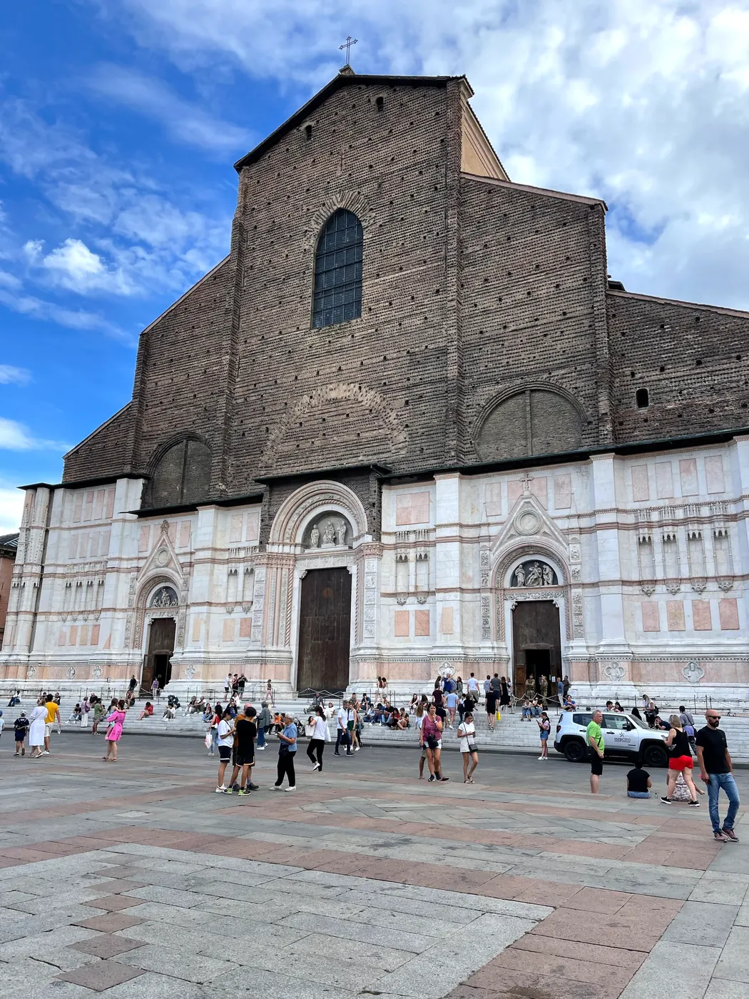 The unfinished brick and marble facade of the Basilica of San Petronio.