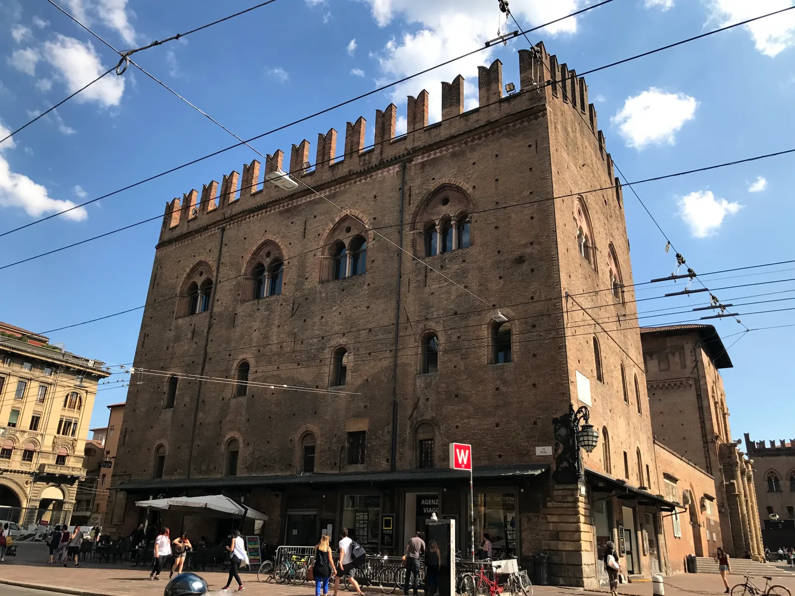 The arcaded facade of Palazzo del Podesta facing Piazza Maggiore.
