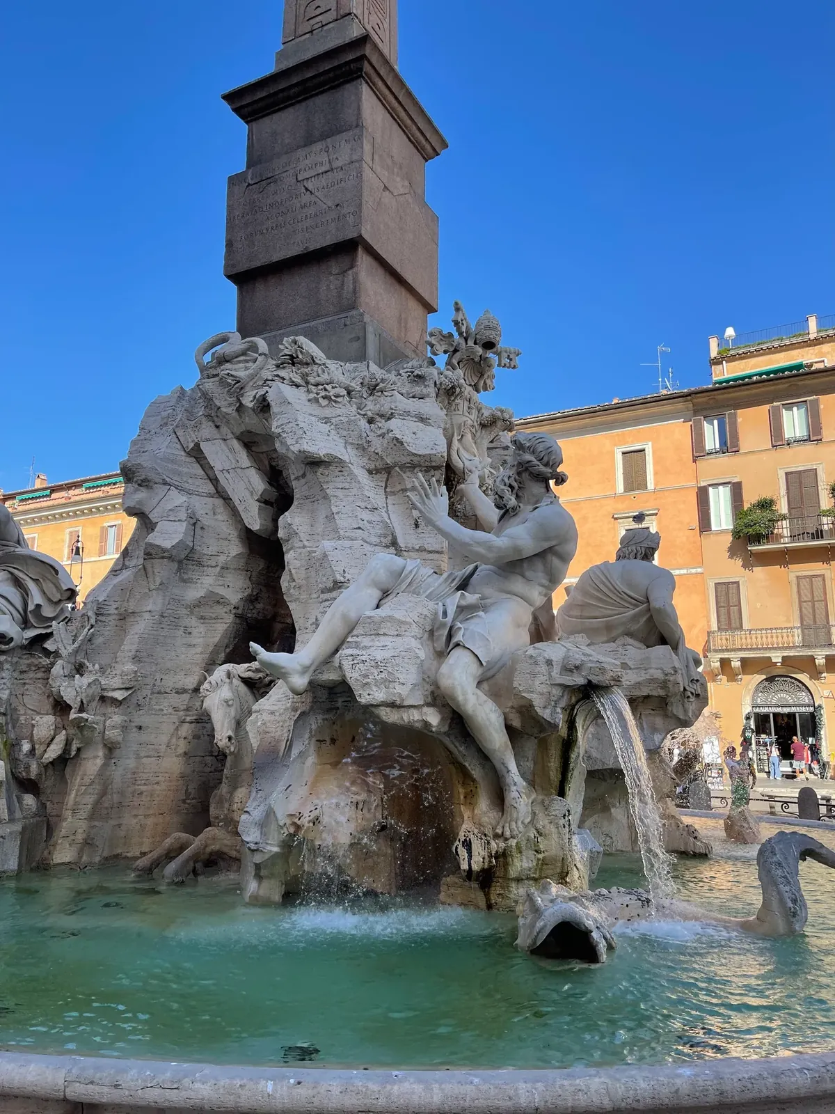 River god Danube statue reaching toward the papal arms with a horse in the grotto below