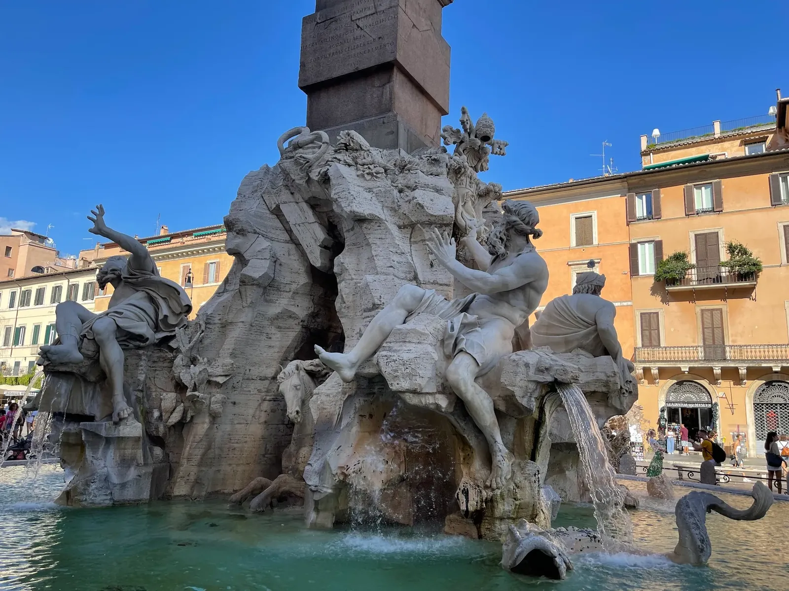 Fountain of the Four Rivers in Piazza Navona with river god statues below the obelisk