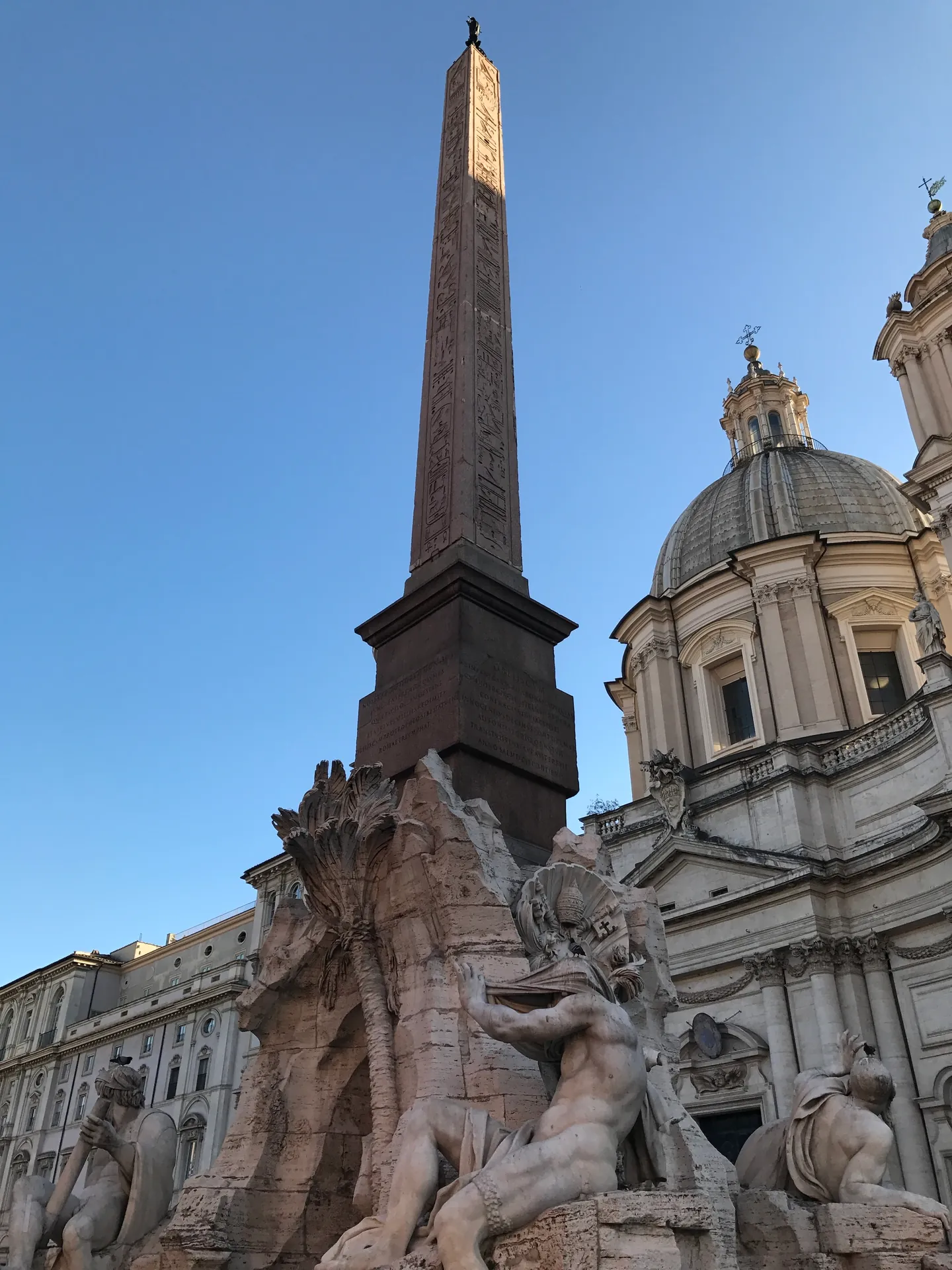 Obelisk of Domitian above the Four Rivers fountain with the dome of Sant'Agnese in Agone