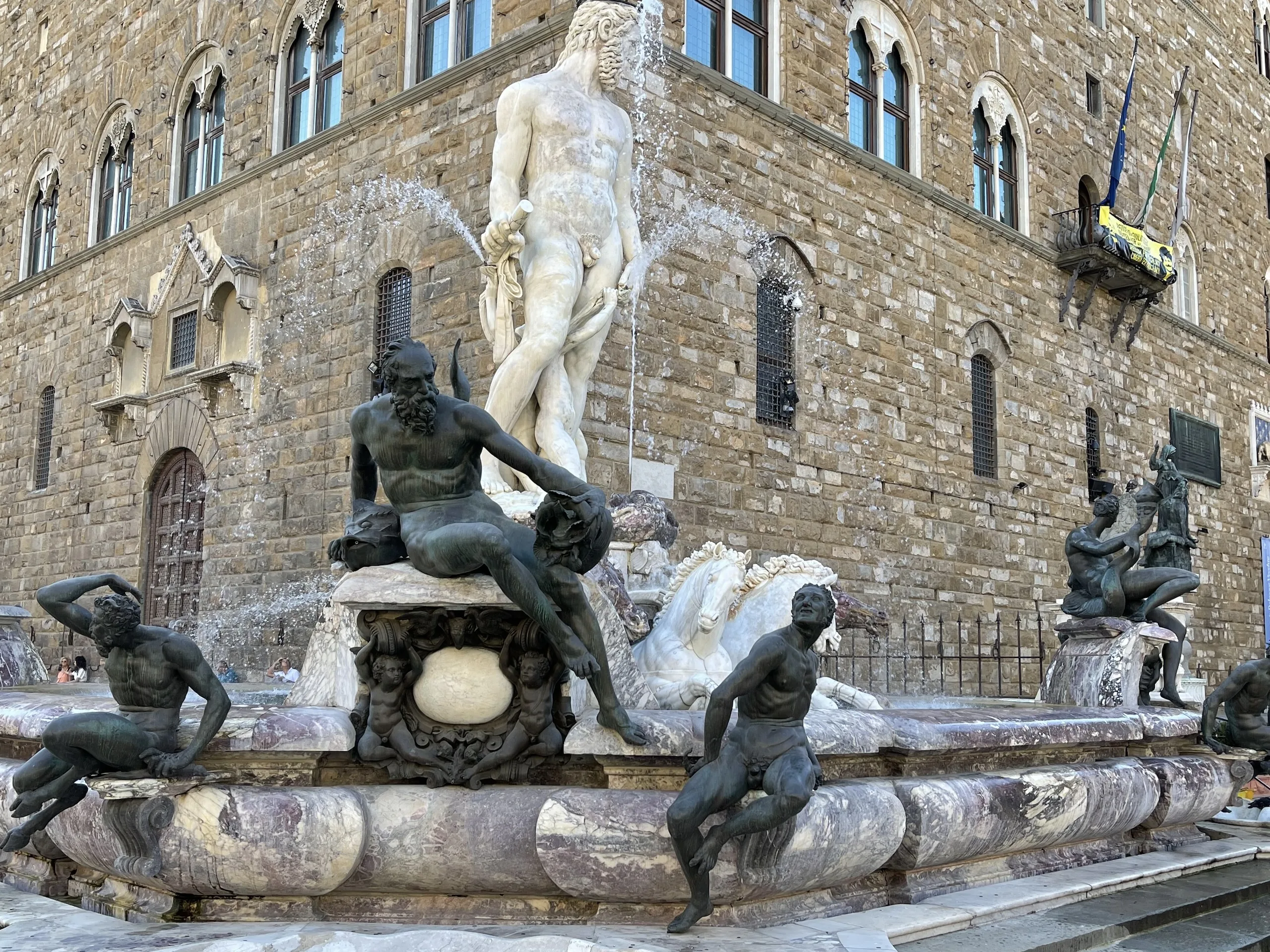 The Fountain of Neptune on Piazza della Signoria, marble figure above a basin ringed with bronzes