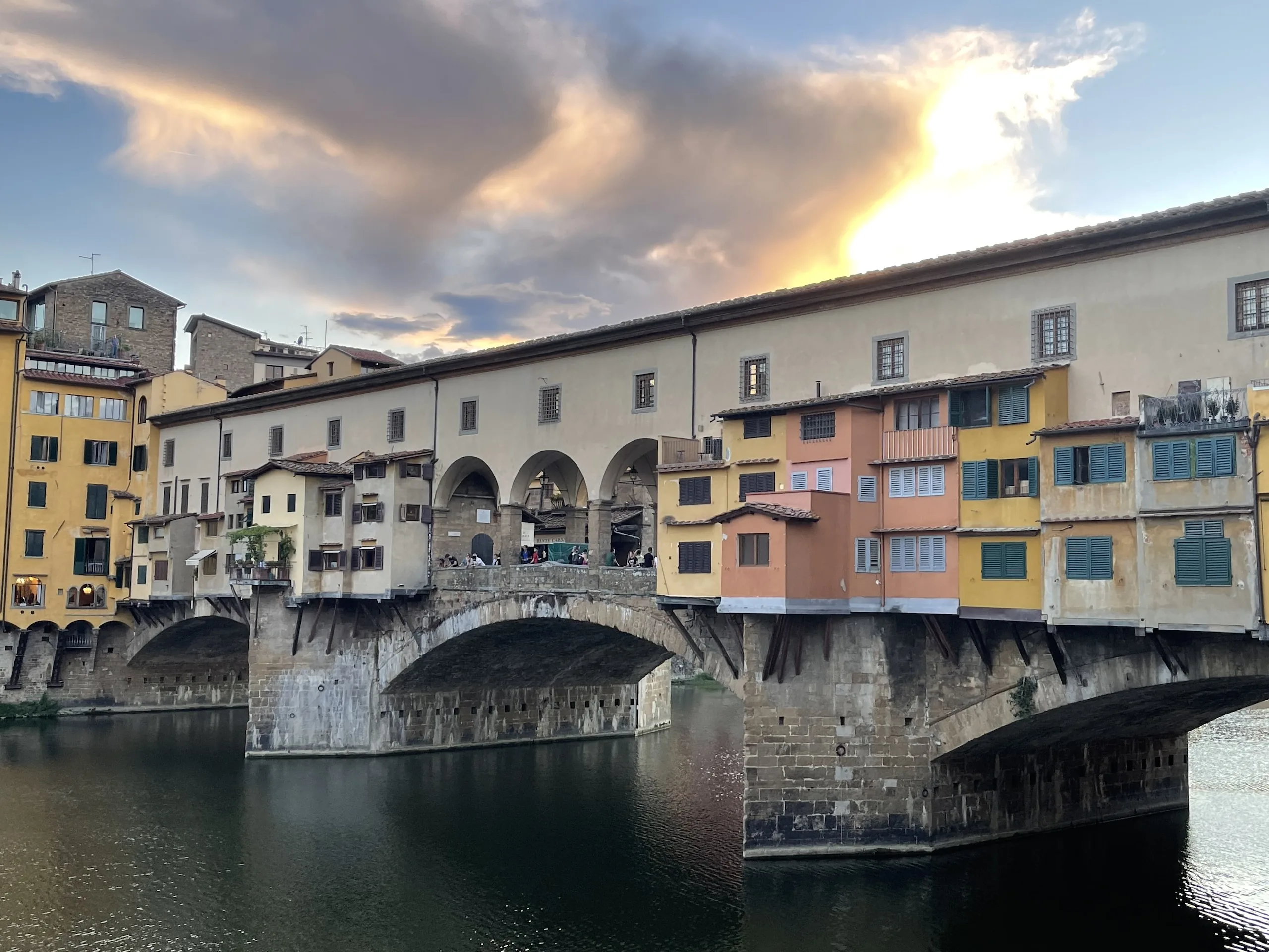 The Ponte Vecchio from the Arno, its shops hanging out over the water on brackets