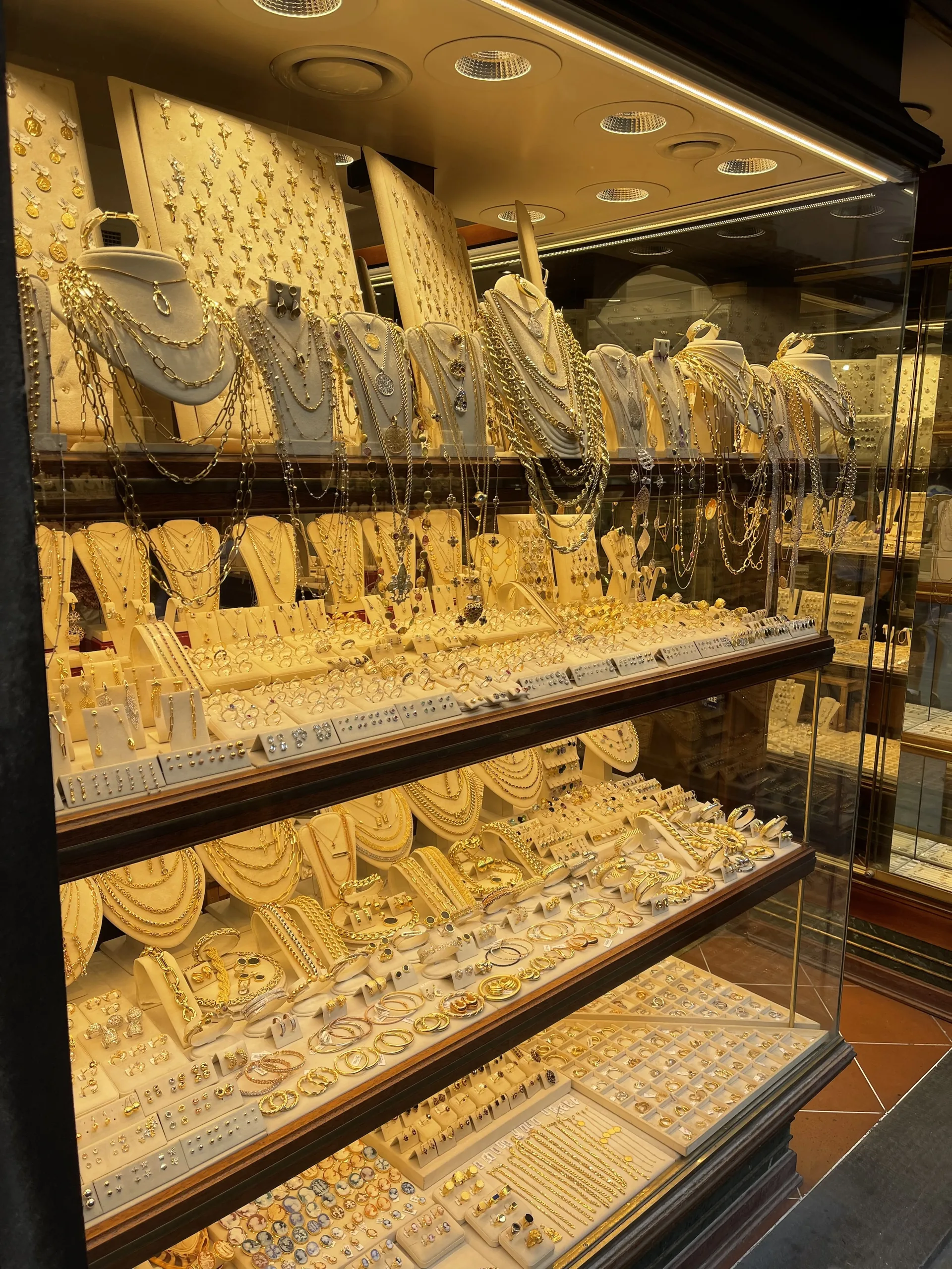 Gold chains and necklaces banked in a jeweller's window on the Ponte Vecchio