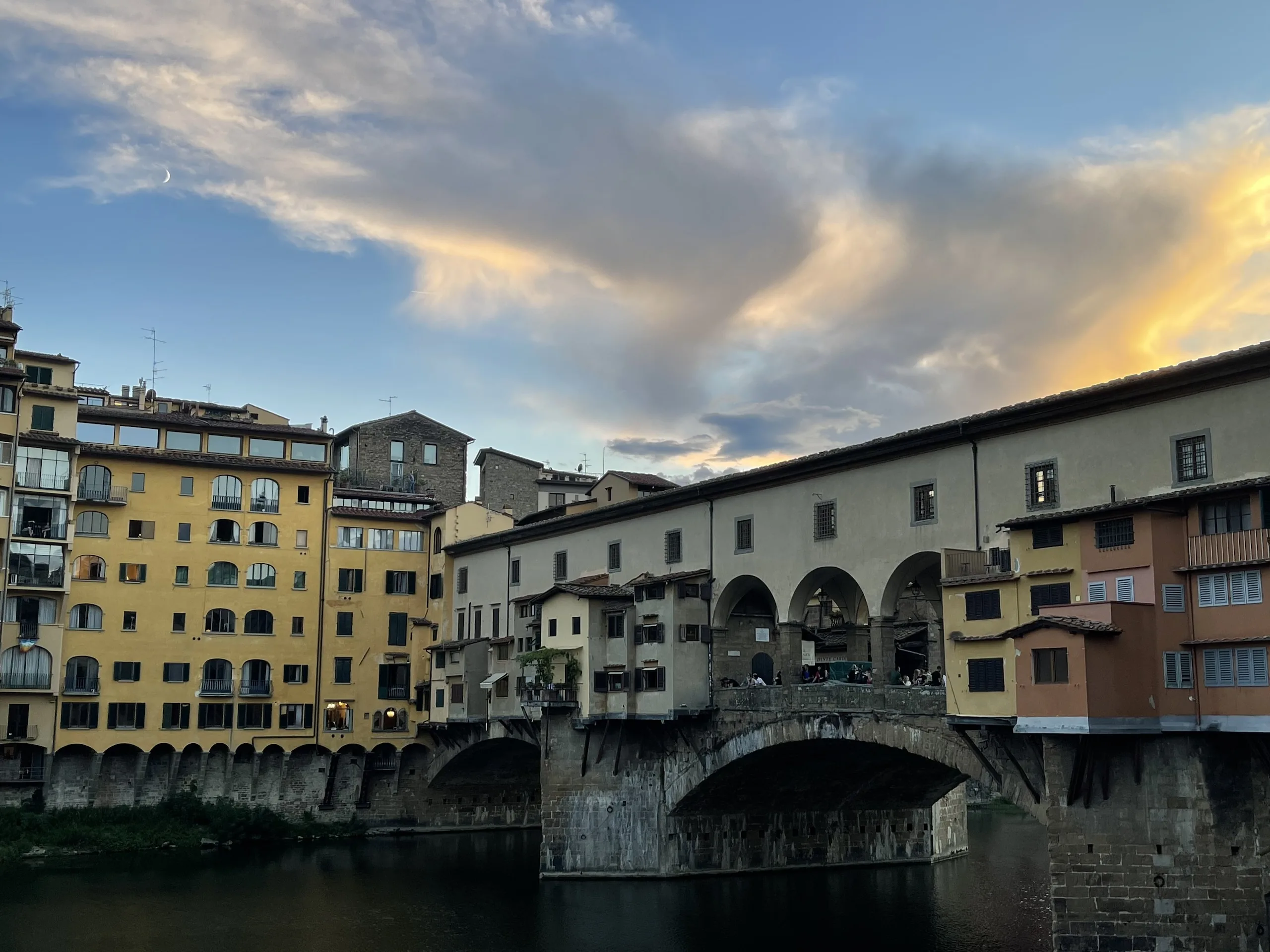 The three segmental arches of the Ponte Vecchio carrying its line of shops across the Arno