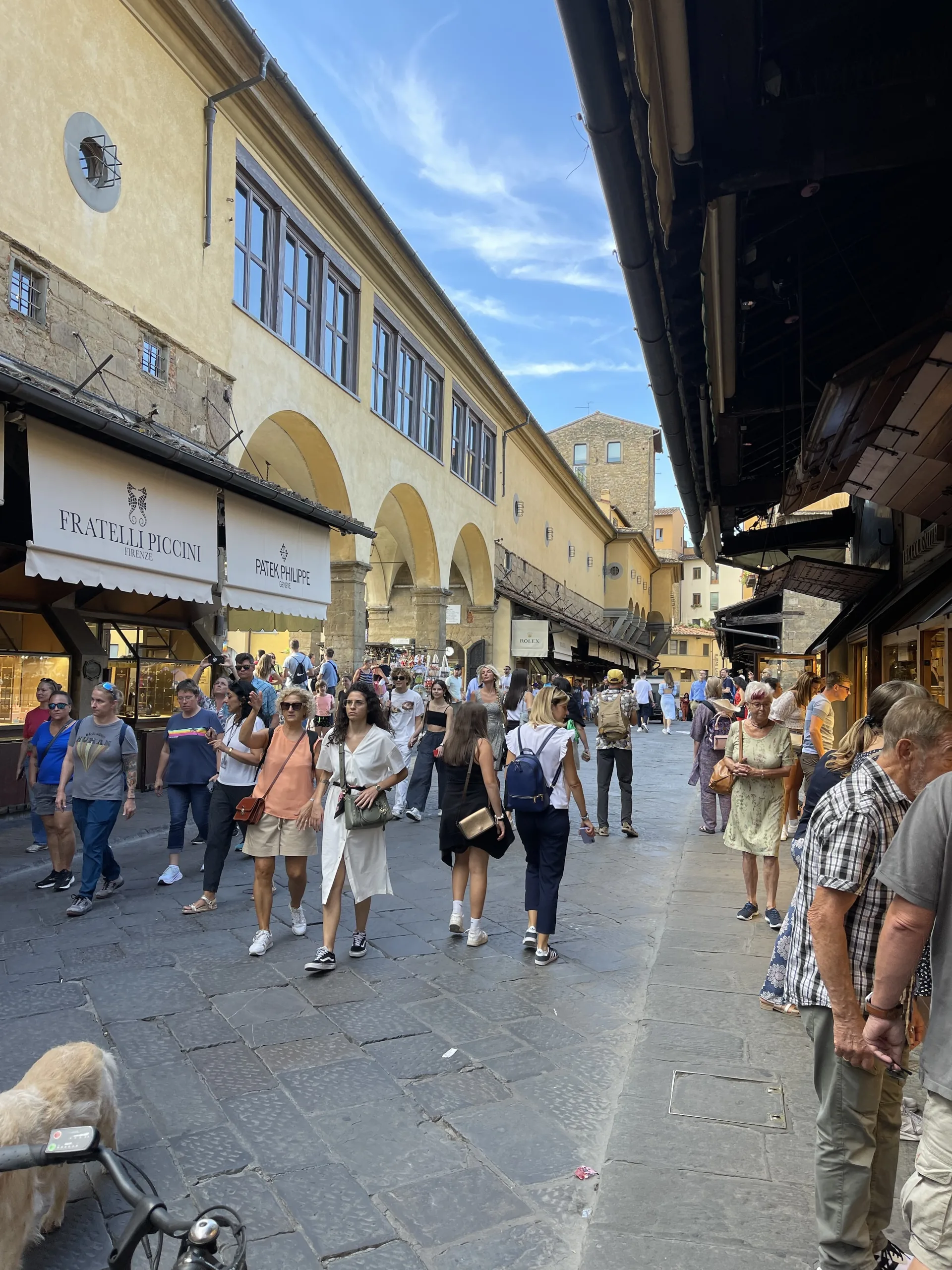 The crowded central walkway of the Ponte Vecchio between its shops