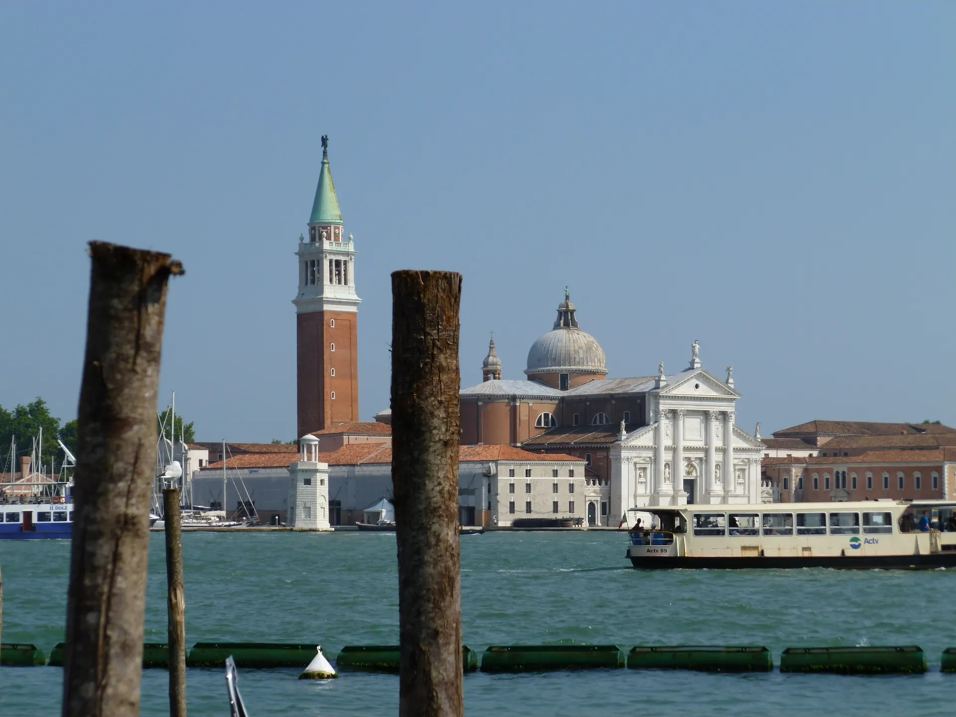 San Giorgio Maggiore framed by wooden mooring poles across the lagoon